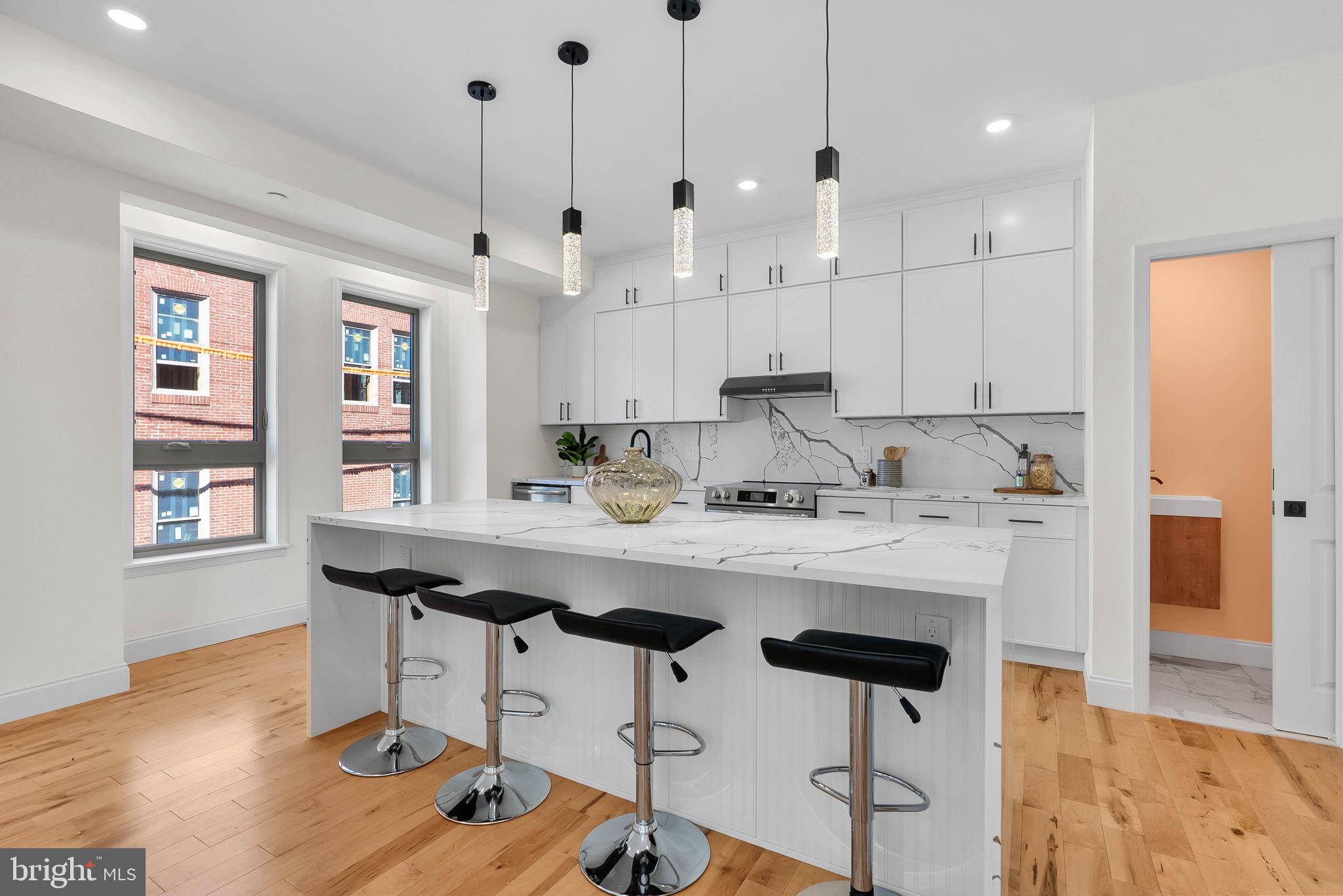 Welcome to 106 Pollard Street, an exceptional 3,100 square foot / 38 foot wide new construction residence of sophisticated living space in the heart of Northern Liberties. Designed with an emphasis on scale, style, and effortless city living, this 4 bedroom, 4 full bath, 2 half bath home features a finished basement, dedicated office space, private rooftop deck, and attached one car garage. The main level showcases wide plank hardwood flooring and an expansive open concept layout, with a striking chef’s kitchen centered around a generous waterfall island and sleek contemporary finishes. A full floor primary suite provides a private retreat, featuring a spacious bedroom and luxurious spa inspired bath with a freestanding soaking tub, dual vanities, and separate water closet. Two additional generously sized bedrooms are located upstairs, while the dedicated office offers flexibility for working from home or accommodating guests. The finished lower level, complete with a full bath, provides valuable additional living space that can be tailored to a media room, fitness studio, lounge, or guest quarters. Ascend to the private rooftop terrace, where a built-in wet bar and sweeping city views create an impressive setting for entertaining or unwinding above the neighborhood. Additional amenities include dual HVAC systems, tankless water heater, abundant storage, 10-year tax abatement, and 1-year builder warranty. Ideally positioned near an array of acclaimed restaurants, cafés, and nightlife, this residence offers a rare combination of architectural scale, elevated finishes, indoor-outdoor living, and an enviable Northern Liberties location. Taxes and square footage is the responsibility of the buyer to verify independently.Listing contains AI enhanced Photos