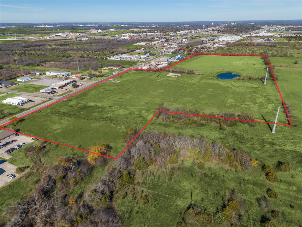 This 42.601 acre tract presents a prime development opportunity inside the Greenville city limits with scale, visibility, & flexibility that is increasingly rare in fast-growing North TX markets. With 1,178 feet of frontage, utilities available including water, sewer, & electric, & the ability to subdivide, this property is well positioned for a mixed-use concept that could include commercial, multi-family, single-family, or a thoughtfully planned combination.The land has already been excavated, offering a head start for development, & currently benefits from a Commercial AG exemption. Location is a major differentiator. The property sits less than one mile from I-30 at Wesley Street, approximately 2.5 miles from FM 1570 & within 3 miles of major employers such as L3 Harris & Innovation First. TxDOT plans to widen Highway 34 & current traffic counts range between 23,000 & 25,000 vehicles per day, adding long-term visibility & accessibility upside.Greenville is experiencing strong, measurable growth. Since 2020, the city has seen a population increase of over 15 percent, outpacing national growth rates, driven by affordability, business expansion, & regional migration from the Dallas metro. Within a two mile radius, approved plats & active developments account for more than 2,500 new homes, creating immediate demand for retail services, housing options, & supporting commercial uses.Surrounding commercial activity continues to expand, reinforcing this corridor as a focal point for future growth. The site is well suited for a mixed-use or age-qualified residential concept paired with nearby retail & services, with zoning flexibility allowing multiple development paths.For developers & investors seeking frontage, infrastructure, proven growth indicators, & entry into one of North Texas’s accelerating secondary markets, this property offers scale, timing, & optionality at an attractive price basis, representing one of the best opportunities on the market today.