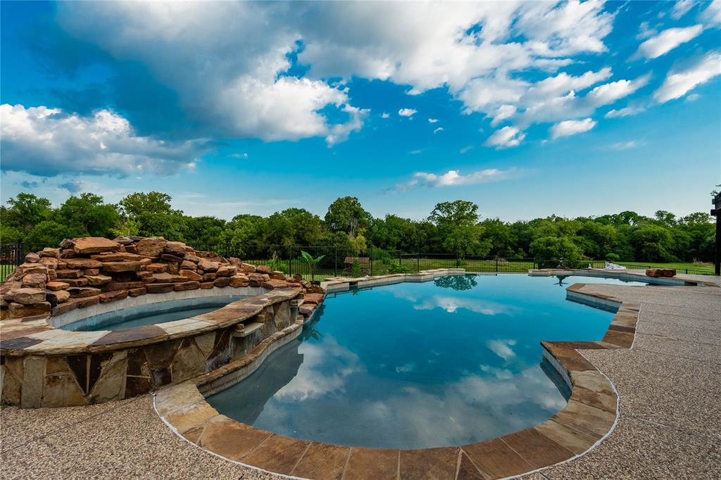 Greeted by a gated entry and winding drive, this 11-acre estate blends timeless elegance with wide-open Texas skies. Perfectly positioned on a coveted corner lot, within walking distance of Breckinridge Park and Firewheel Golf Park, it offers the rare combination of privacy, beauty, and convenience.

The property has grown in both size and stature in recent years—most notably with the purchase and addition of 2 acres along Campbell Road, creating a more expansive and versatile estate. Alongside this, the home has undergone extensive remodeling, including a reimagined first floor, a stunning new kitchen, and a beautifully updated pool area that feels more like a boutique resort than a backyard.

Inside, sunlight pours through remodeled windows, filling spaces designed for both comfort and connection. The oversized downstairs primary suite is a retreat of its own, while thoughtful touches like an office, expanded utility room, bonus storage, and even a built-in dog spa make everyday living seamless.

The new kitchen—with custom cabinetry, a marble-textured backsplash, premium appliances, and walls opened to enhance flow—anchors the heart of the home. Living and dining spaces center around a striking second fireplace, while upstairs offers a media room, an additional family room, and a balcony overlooking the landscape.

Step outside to enjoy the 10-foot infinity-edge pool, outdoor kitchen, and cabana-style lounge perfect for entertaining under the stars. Wander to the pond for fishing or quiet reflection, or watch children (or the young at heart) explore the whimsical treehouse. Towering mature trees and open fields invite horseback riding, gardening, or simply savoring the peace.

Completing the estate is a 3-car garage with storm shelter, ample parking, and an additional 2,600± sq ft building ready to become guest quarters, a workshop, or even a private venue.

Here, every sunrise and sunset feels like it was painted just for you.