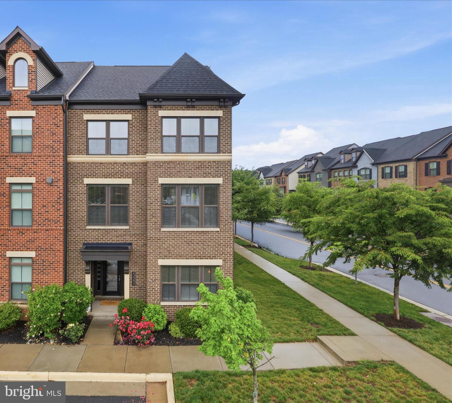 Nestled in the desirable community of Westmoore at Moorefield, this exquisite end-of-row townhouse offers a harmonious blend of luxury and comfort, perfect for those seeking an elevated lifestyle. Built in 2017, this residence boasts a traditional architectural style, showcasing impeccable masonry craftsmanship that stands the test of time. Step inside to discover a spacious 3,710 square feet of thoughtfully designed living space. The open floor plan seamlessly connects the kitchen, dining, and living areas, creating an inviting atmosphere ideal for both entertaining and everyday living. Elegant wood floors and recessed lighting enhance the warmth of the interiors, while large double-pane windows bathe the space in natural light, offering serene views of the adjacent park and greenbelt. The gourmet kitchen is a chef's dream, featuring high-end ENERGY STAR appliances, including a built-in microwave, wall oven, and a sleek cooktop. An eat-in area and pantry provide both functionality and style, making meal preparation a delight. The adjoining living area, complete with a cozy gas fireplace, invites relaxation and gatherings with loved ones. Retreat to the luxurious primary suite, where a spa-like bathroom awaits. Indulge in the soaking tub or rejuvenate in the walk-in shower, surrounded by elegant finishes that exude sophistication. The exterior of the home is equally impressive, featuring a roof deck perfect for enjoying sunsets or hosting intimate gatherings. The community amenities include a stunning saltwater pool, ideal for exercise or leisure, along with meticulously maintained grounds that include lawn care and snow removal, allowing you to enjoy a low-maintenance lifestyle. Additional highlights include a two-car attached garage with extra storage, a state-of-the-art security system, and energy-efficient features throughout, including a tankless water heater and air filtration system. Experience the exclusive lifestyle that this remarkable property offers, where luxury meets convenience in a vibrant community setting. This home is not just a place to live; it's a sanctuary that invites you to create lasting memories.