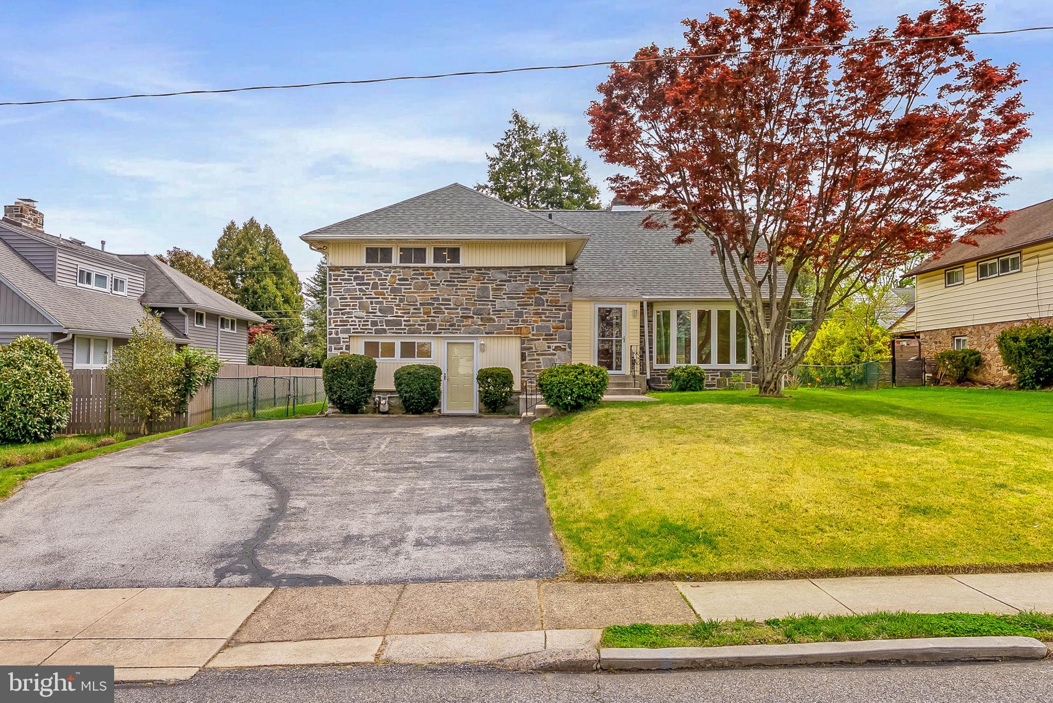 Newly renovated with clean, modern finishes throughout, 129 Whitemarsh Rd offers a bright, airy feel across its flexible 2,700+ sqft floor plan. This spacious home features 4 bedrooms, 3.5 bathrooms, a finished basement, a deck, a large backyard, and placement in the top rated Haverford Township School District. Out front, a handsome stone facade, mature trees, manicured shrubs, and an oversized driveway create welcoming curb appeal on a quiet, treelined block in sought-after Ardmore. Inside, wide plank floors run throughout the open, inviting interior, anchored by a fireplace mantel and a floor-to-ceiling bay windows that fill the living room with natural light. The layout flows easily into the dining room, creating a great setup for entertaining. The gleaming all-white kitchen is fitted with shaker cabinetry, stainless steel appliances, quartz countertops that continue up the backsplash, and breakfast bar seating. Sliding doors lead to the deck, patio, and expansive backyard, providing plenty of space for barbecues, gardening, and outdoor play. More living space is found on the lower level in the huge family room, along with a powder room, a separate finished basement, and a laundry room with extra storage. Up on the second level, the primary suite has lots of closet space and a sleek attached bathroom. Two more spacious bedrooms and another modern bathroom are down the hall. Topping off the home is a second bedroom suite with its own bathroom. In addition to everything inside, 129 Whitemarsh Rd is located just off Darby Rd and Eagle Rd, close to shopping centers along West Chester Pike and Lancaster Ave, including Suburban Square. Parks and golf clubs are also nearby, plus there’s easy access to I-476 and Center City Philadelphia via Regional Rail. Schedule your tour today