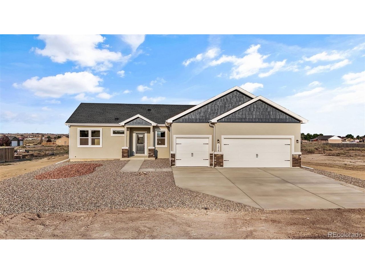 Experience Colorado ranch living in "The Whisper," a newly built single-level floor plan situated on a quiet 1 acre lot. This 3-bedroom, 1,904 sq. ft. rancher perfectly blends modern style with everyday comfort, featuring 9-foot ceilings, a wall of windows, and breathtaking mountain views. The open-concept layout seamlessly connects the kitchen, dining, and living areas. In the living room, functional built-in shelves sit next to a large wall space designed for a flat-screen TV. The chef-inspired kitchen boasts granite countertops, a large island, stainless GE appliances, soft-close cabinetry, a walk-in pantry, and a bright dining space. A convenient walk-out door from the kitchen provides seamless indoor-outdoor living, perfect for entertaining. Retreat to the private primary suite featuring a luxurious 5-piece spa-style bath with a soaking tub, separate walk-in shower, and dual granite vanities. Three additional spacious bedrooms and a full guest bath provide ample room for family, guests, or a home office. Built for efficiency, this fully electric home includes central A/C and modern systems to help lower utility costs. Additional features include a dedicated mudroom/laundry room and a 3-car garage with abundant space for vehicles, storage, or a workshop. Outside, enjoy a low-maintenance stucco exterior and a xeriscaped front yard with turf. The expansive acreage lot offers endless opportunities for gardens, pets, and potential RV parking. Ideally located minutes from I-25, you are less than 35 minutes from Colorado Springs and only 10 minutes from Pueblo. The Whisper is not just a home-it is a lifestyle. Prime location, modern comfort, and unmatched views make this move-in-ready property perfect for your next chapter. Schedule your showing today!