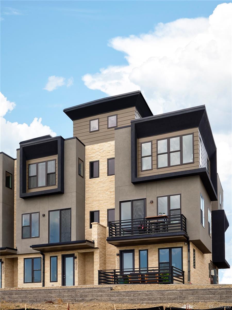 Welcome to Montmere at Autrey Shores, where elevated design meets exclusive waterfront living framed by breathtaking mountain views. This Suncrest B plan model home offers refined townhome living in the sunny and sought after town of Superior. Offered with the option to purchase fully furnished, this residence features extensive designer upgrades and delivers exceptional functionality and style across every level. Furnishings are not included in the list price.”The entry level features a versatile flex space ideal for a home office, media room, or guest retreat, enhanced by inspiring views of the mountains and Autrey Reservoir. Enjoy the convenience of both a private elevator and stairs leading to the main living level, where a show stopping chef’s kitchen takes center stage. Highlights include a dramatic ten foot quartz waterfall island, built in cooktop with hooded vent, double ovens, and generous seating, perfect for entertaining and everyday living. The open concept living area is anchored by a gas fireplace with an elegant dark tile surround and showcases the home’s signature water and mountain views. A spacious dining area with distinctive ceiling and wall details completes this inviting space for gatherings.The third level is dedicated to rest and retreat, featuring a generously sized primary suite with a striking shiplap accent wall, five piece spa inspired bath, upgraded built in closet storage, and sweeping views of the water and mountains. Guests will appreciate the thoughtfully designed secondary bedroom options, offering both plush carpeted comfort or hardwood flooring with a unique designer wall feature.Enjoy one of a kind water and mountain views from the living room, primary suite, and rooftop deck. Ideally located within walking distance to the Broomfield Outlets, Flatiron Crossing Mall, Life Time Fitness, dining, and entertainment. Downtown Superior is just seven minutes away and features Target, Costco, Whole Foods, and more.