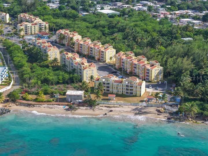 Spectacular Location • Beachfront • Wonderfully cared for Income Generating Vacation Apartment. Spacious enough for full time living with an open concept living space. This lovely property has been remodeled with tasteful quality materials & offers a very smart distribution with two balconies and fantastic cross ventilation. Within the Community, this second floor Condo faces one one of two pools and water views. Layback in the generously sized posterior balcony and enjoy your refreshments while you overlook the pool and the soak in the beach views.  Upgrades galore (granite kitchen countertop, pvc cabinets, storm shutters, aluminum upgrade doors, both Guest & Ensuite Bathrooms remodeled, laundry and storage closet). Kitchen has been remodeled and offers pvc cabinets with pantry closets and custom granite countertops. In addition, both bathrooms have been redone, all doors have been replaced with aluminum custom doors. For your peace of mind, the Condo has Storm Shutters already installed. Complex is Oceanfront offering direct beach access, 24 hour security, 2 Pools, Gmy, Courts, 2 Titled Parking Spaces & Guest Parking. Villas del Mar Beach Resort, allows short term vacation rentals  & the property has documented Vacation Rental income, showing it's successful bookings. HOA$178 • CRIM PROPERTY TAXES 1,396 yearly.This property is more than just a vacation rental, it's a stream of income already flowing.