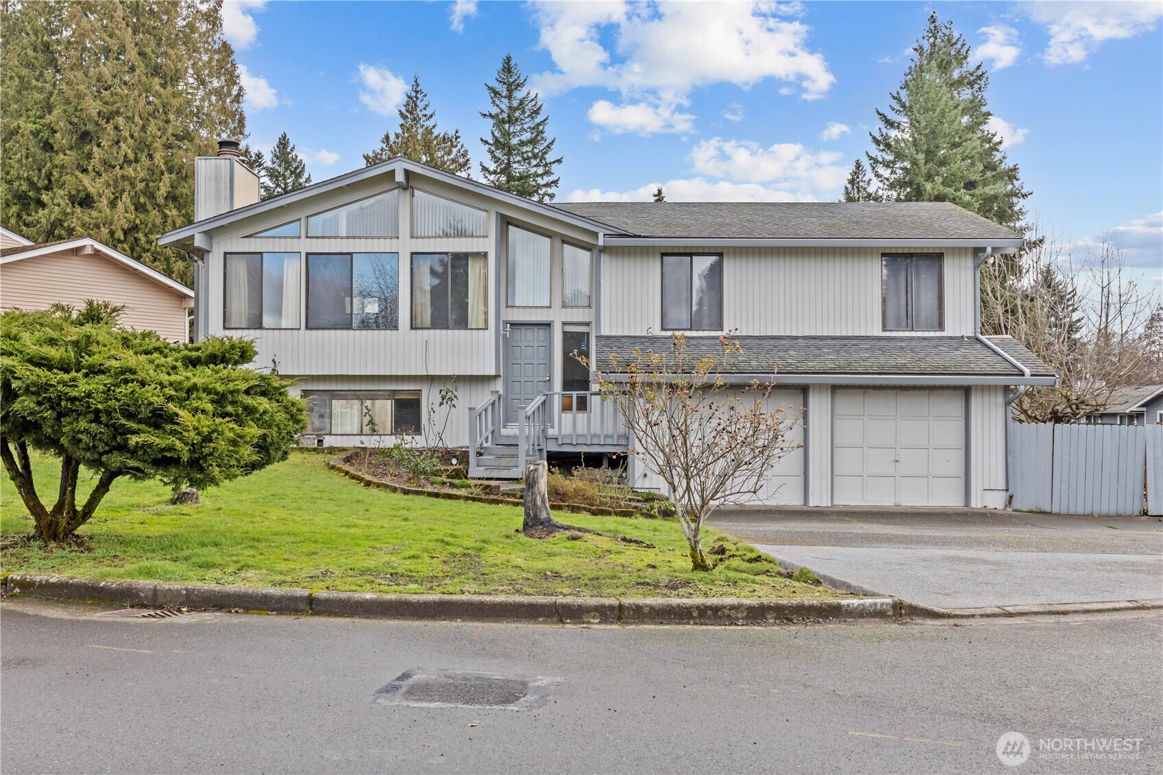 Welcome to this spacious split-entry single-family home offering 4 bedrooms, 1 full bath, and two ¾ baths. Designed for both comfort & functionality, the main level features a large Living Room with wood burning fireplace, vaulted ceilings and a stunning window wall that fills the space with natural light. This home also offers a large Dining Room providing plenty of room for gathering and the Eat in Kitchen includes direct access to the back deck, perfect for outdoor dining & entertaining. The Primary Bedroom with private bath, 2 other Bedrooms & a Full Bathroom are also located on this upper level.  Downstairs, you'll find a spacious Recreation Room anchored by a charming Brick Fireplace, creating a warm and inviting space for relaxing, playing or hosting guests.  A 3/4 Bath, Laundry Room and Private 4th Bedroom are also located on the lower level.  Step outside to enjoy the large, Fully Fenced Backyard with ample room to garden, to play or keep your pets safe in the Oversized Backyard.  RV Parking adds convenience and flexibility for all your storage needs.  The home is ideally located with easy Freeway Access and just minutes from Shopping, Dining, and other everyday amenities, all providing Comfort, Space, and Convenience. Don’t miss the opportunity to make this versatile property your own!