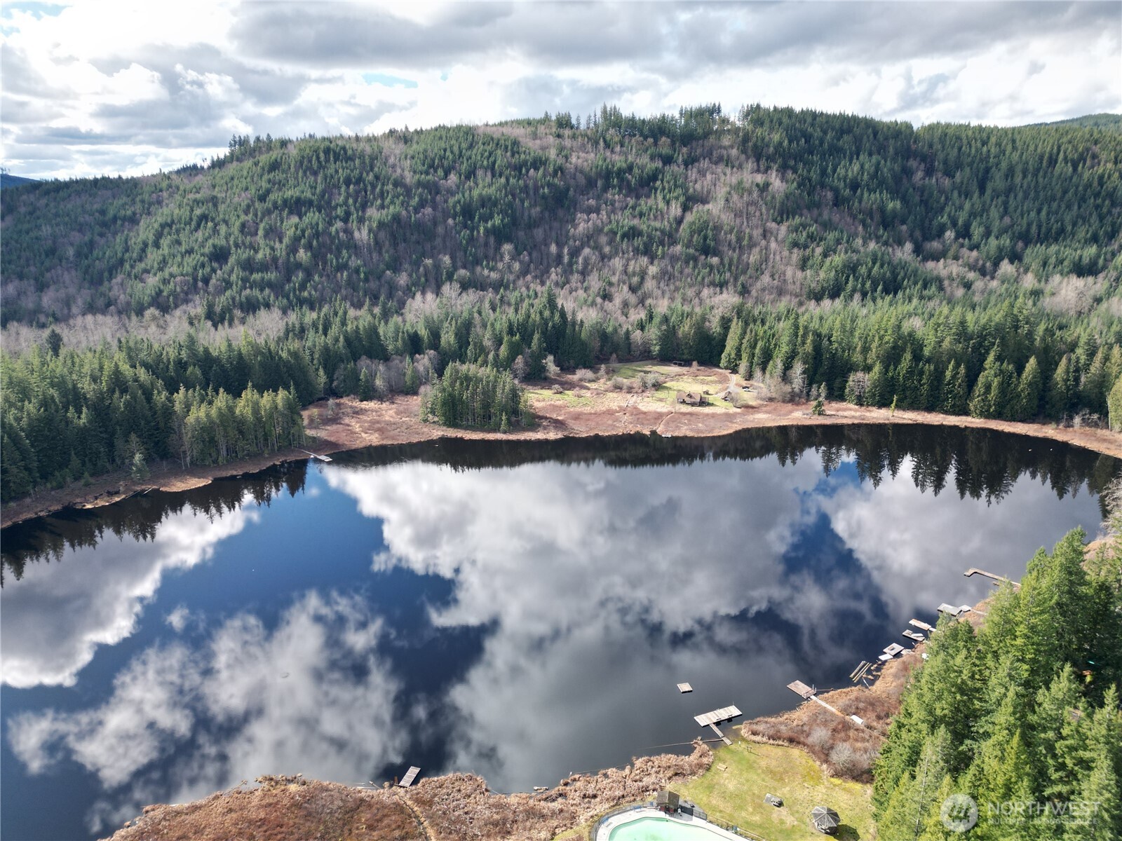 239+ acres of premier Pacific Northwest land on Lake Riley with 1,325 ft of shoreline and direct DNR land access. This rare Arlington legacy property includes 7 parcels, a historic farmhouse, and a 1996 A-Frame cabin. Ideal for outdoor living and recreation with private hiking and ATV trails, pastures, fishing, hunting, and abundant wildlife. Mature timber adds long-term investment value. Build a custom waterfront dream home or create a private estate with multiple residences. Just one hour from Seattle and close to Arlington amenities. Held by the same family for 125+ years, this extraordinary property offers unmatched privacy, natural beauty, and estate potential. Opportunity: Owners are open to Seller Financing with agreed-upon terms.