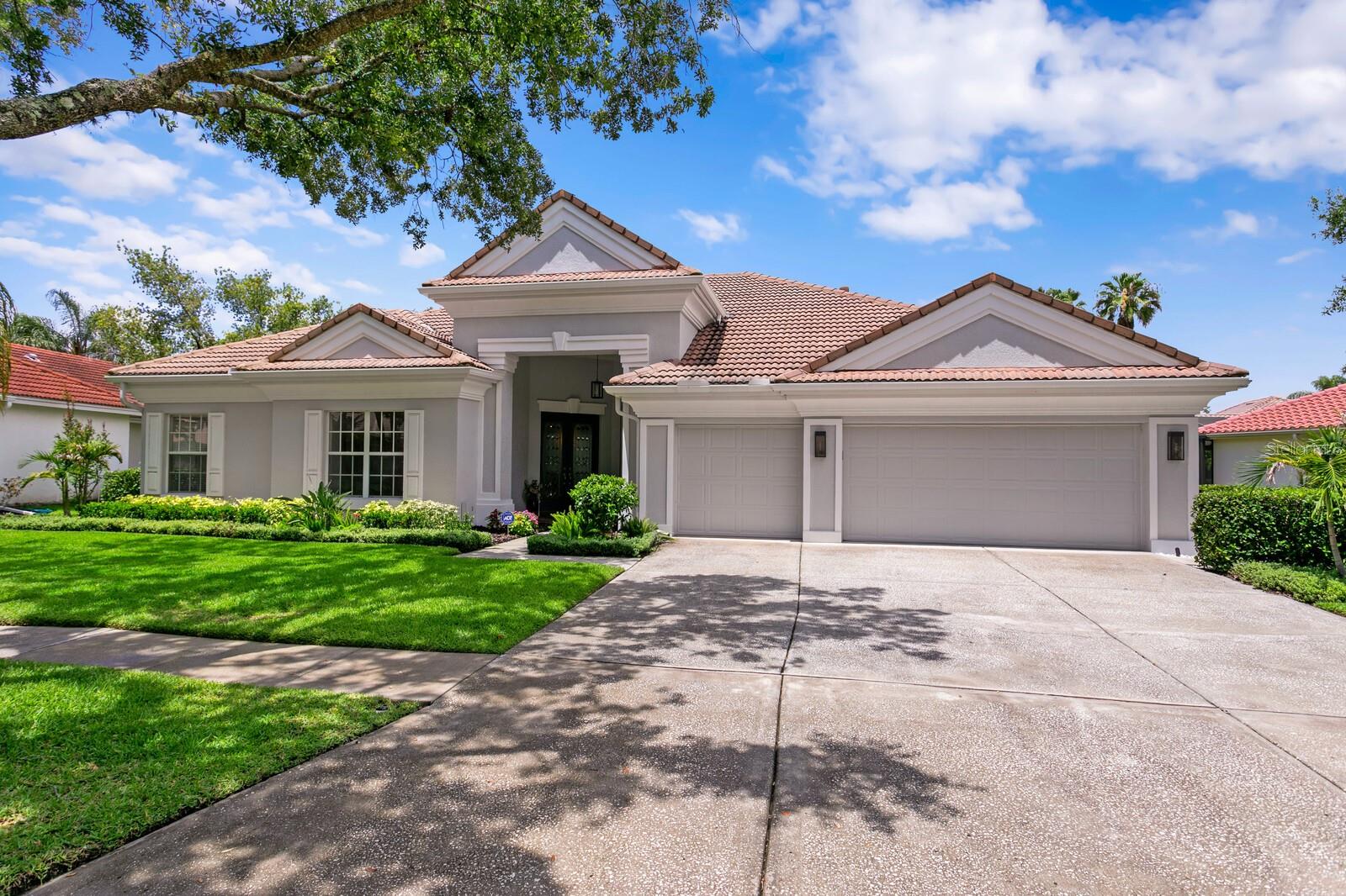 **Contemporary Elegance with Over $170K in Upgrades in Arbor Greene**

Located in the exclusive double-gated village of Arbor Greene, this beautifully enhanced home offers 4 bedrooms, 3 bathrooms, a private office, and a spacious bonus sitting room, set against a tranquil pond with stunning water views. Blending contemporary comfort with curated upgrades, this home is a true standout in both style and substance.

Step into a bright, welcoming foyer showcasing sleek tile floors with contemporary marble pattern. This grand area is flanked by a dedicated office with front-facing windows and custom built-ins. The adjacent formal living and dining rooms are elevated by a new designer chandelier and LED lighting, while nearby, a stylish wine sitting room offers a built-in dry bar, wine fridge, and custom lighting, perfect for entertaining or relaxing at home.

The kitchen and family room serve as the heart of the home, featuring refreshed cabinetry (2024), new stainless appliances (2023), a center island with granite surface and updated lighting that opens effortlessly into a spacious family room overlooking the pond. Pocketing sliders frame the picturesque view and flood the space with natural light.

The primary suite is tucked away in its own wing for maximum privacy and features custom blackout curtains (2022), dual walk-in closets with custom built-in systems (2022), and a beautifully updated en-suite bath with refreshed cabinets (2024), new hardware, Toto toilet with bidet (2022), and updated faucets and showerhead (2025).

Three additional bedrooms are situated on the opposite side of the home alongside two guest bathrooms refreshed in 2023 with updated vanities, lighting, hardware, and Toto elongated toilets, designed to offer both function and sophistication. A flexible bonus sitting room in the rear of the home provides the perfect space for a media room, playroom, or guest quarters.

Thoughtful upgrades continue throughout the home, including:

New interior paint (2022) and all-new LED lighting (2022),
New ceiling fans throughout (2022),
removed carpet (2022),
Hello Garage Polyurea garage flooring (2022),
Fresh exterior paint and new LED exterior lighting (2022),
New landscaping, walkway, irrigation, and French drain system (2023),

And now, the showstopping finale, your private outdoor oasis.
The screened lanai has been fully updated with new travertine pavers (2022), resurfaced saltwater pool and spa (2022), a new pool heater, filter system with remote app control (2022), new pool lighting (2023), and all-new screens (2023). Entertain effortlessly in the custom outdoor kitchen (2023), complete with gas hookups and a Green Egg smoker, all cooled by dual patio ceiling fans (2023).

As a resident of Arbor Greene, you’ll enjoy resort-style amenities including two community pools, a fitness center, Har-Tru tennis courts, playgrounds, and miles of scenic walking trails. Located near top-rated schools, I-75, Wiregrass Mall, and excellent medical and dining options, this home offers the very best in luxury, location, and lifestyle.