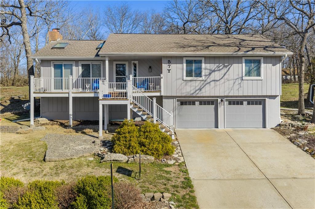 Come live the lake life in this gorgeous 2nd tier home!  Enjoy the beautiful view of the lake from the large front porch and relax on the huge, private, treed backyard deck.  Plenty of wild life to enjoy around the firepit area. This cozy updated home gives off a lovely beach vibe with adorable ship lap, open floor plan, fireplace, and plenty of storage room in the upstairs attic space.  Vaulted ceilings, hardwood and LVP throughout, and the kitchen is a show stopper.  Granite, kitchen island and all appliances stay with the home (including the washer and dryer in the oversized laundry room) and a bonus sunroom/office space right off the kitchen with an outstanding view of the backyard. The finished lower level offers a fireplace and full bathroom - could easily be a 4th bedroom area. Roof age 8 years, HVAC 4 years new, hot water tank 3 years new and all suggested foundation work has been completed (see supplements).  Completely move-in ready so you can start enjoying the lake life while also enjoying nature in the privacy of your backyard!  No dock registered to property but easy access to the lake right down the street.