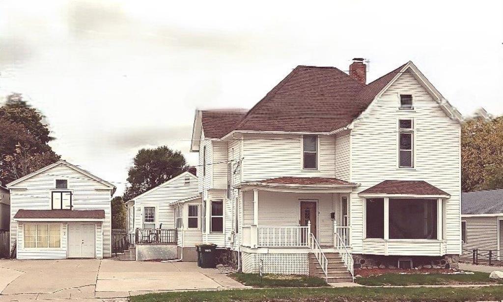 Attention Investors! Excellent Rental Opportunity on this 3 unit home. One unit is a 2 bedroom apartment, Two units are  1 bedroom apartments. Gorgeous Hardwood Floors and vintage custom woodwork is absolutely beautiful! Lots of updates in the last 12 yrs, including.. New roofs, windows, siding, kitchens, baths, flooring, blown insulation and more! All 3 units have newer appliances.... stoves, refrigerators, dishwashers, washers and dryers. 2 units have basements for extra storage,  Move in ready! Live in one apartment, rent out the other 2 apartments for additional income. Would also be perfect for an in-law situation. Plus an additional  out building for storage area or use for your  business. Currently zoned residential but could be rezoned to utilize this building as your own storefront. Located 1 block off Main St, perfect location with lots of traffic.  Call today to schedule your showing!