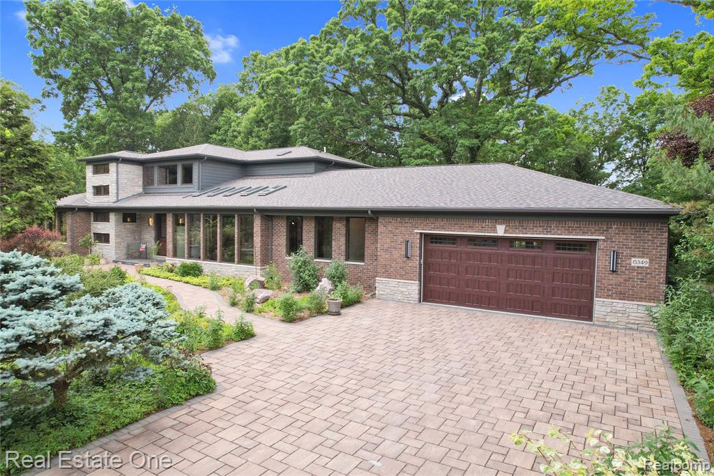 Perched Above a Small Natural Lake—A Modern Masterpiece in Harmony with Nature ** Tucked into a pristine 1.25+/- acre wooded bluff and overlooking a small, serene lake approx. 85 ft below, this architectural gem is more than a home—it’s a retreat for the soul. Custom built in 2016 w/ 5,300+/- fin SFT, every inch is designed to elevate your lifestyle while honoring the beauty of its natural surroundings. ** The heart of the home is a jaw-dropping kitchen with granite counters, JennAir appls, prep sink, walk-in pantry, and oversized island—all framed by a wall of windows offering uninterrupted forest and lake views. The main-floor primary suite is a sanctuary unto itself, featuring a spa-like bath w/ walk-in shower, soaking tub, fantastic walk-in closet, and space for future sauna. Living & family rooms, dining, ofc, powder room, and large mud room round-off main level. ** Upstairs, two guest suites (each w/ private baths) and a loft with wet bar and balcony deliver unmatched treetop views. ** Downstairs, a current fitness studio w/ full bath could easily flex into a fourth ensuite. ** With 4-car tandem parking garage, rain-sensing skylights, two geothermal HVAC systems (7-ton, tri-zone), smart-home automation, copper plumbing, foam insulation, and bamboo-resin floors—no detail has been spared. Add in a solarium-style indoor garden w/ drywell, two fireplaces, and LED in-tile lighting in driveway, walkway, and front/back patios, and the result is pure serenity, and style. ** Artfully landscaped, herbicide-free for 14+ years, and daily visited by wildlife, this home is a rare fusion of luxury, sustainability, and storybook setting. ** Whole house/garage vacuum, 8 ft doors on main floor, I-beam supported main living area, 80 gallon heat pump water heater, prewired 20A outlet in basement for IR sauna, 3" automotive-grade stone in driveway, and SO much more! ** Experience a property unlike anything else on the market, truly. ** All M&D approx. and to be verified. BATVAI.