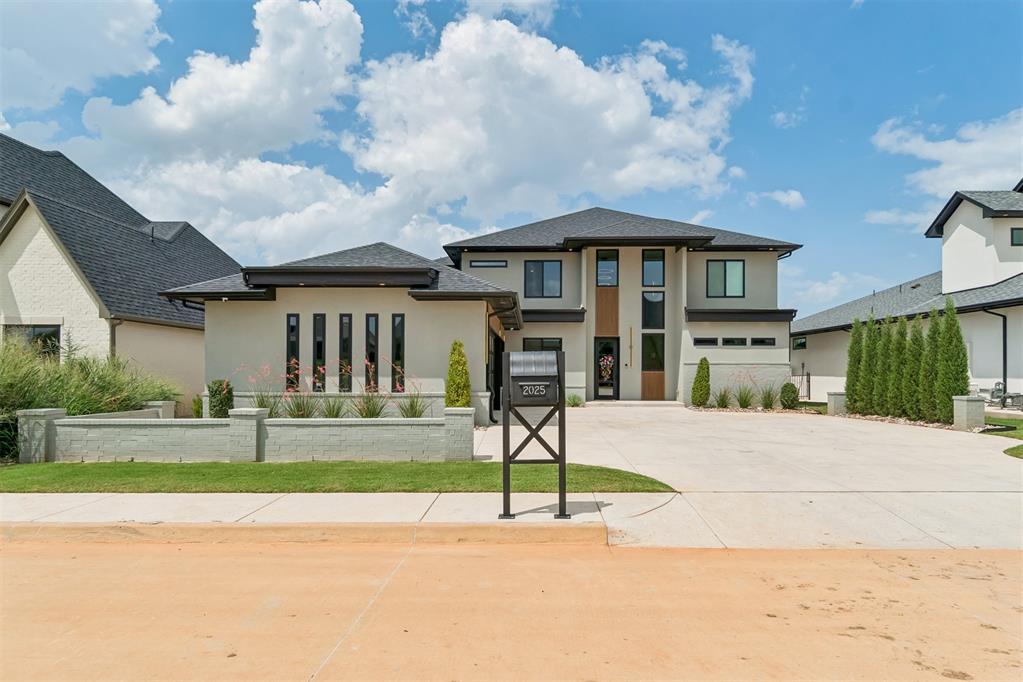 Experience refined luxury in this exceptional golf course residence overlooking the 11th and 12th fairways of Oak Tree's prestigious West Course. Designed for both elegant entertaining and effortless everyday living, this home showcases breathtaking views and timeless craftsmanship throughout. A dramatic two-story great room, framed by soaring ceilings and expansive windows, fills the home with natural light while capturing picturesque fairway vistas. The grand two-story foyer makes a stunning first impression, featuring custom iron stair railings and rich white oak flooring that continues seamlessly up the staircase. The heart of the home is thoughtfully designed with an open-concept layout connecting the chef's kitchen, spacious dining area, great room, and a fully appointed wet bar—creating the perfect setting for hosting gatherings of any size. Just beyond, the expansive covered patio with a built-in grill extends your living space outdoors, offering an ideal backdrop for relaxing evenings overlooking the course. The private primary suite serves as a luxurious retreat, complete with a spa-inspired bath featuring an oversized walk-in shower and an expansive closet filled with natural light. A versatile downstairs flex room is perfectly suited as a nursery, guest suite, or sophisticated study, while a dedicated home office provides a quiet space for remote work. Upstairs, you'll find a spacious game room, three generously sized secondary bedrooms, and two full bathrooms, offering comfort and privacy. Completing the home is an oversized three-car garage, along with an additional tucked-away parking space for guests. Extra upgrades include: lighting, auto shades in every room, upgraded lighting/audio system, added fireplace on patio and green egg holder, added shelving in the garage and epoxied garage floor. Every detail has been carefully considered to deliver an exceptional lifestyle in one of Oklahoma's most sought-after golf course communities.