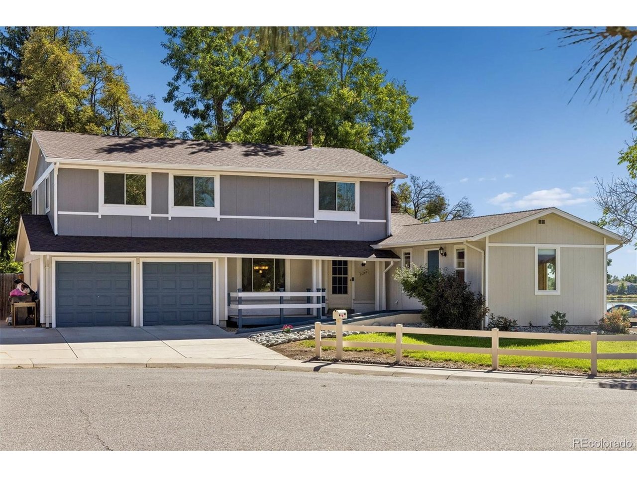 If location, space and flexibility are high on your list, this Lake Arbor home deserves a closer look. Set on a desirable corner lot in the established Lake Arbor community in Arvada. This spacious two-story home puts parks, trails, greenbelts and the lake right outside your door. Amazing lake views from inside the home and the backyard!  Add nearby golf, shopping, restaurants and convenient access to major roadways-with a minimal voluntary HOA fee-and you have a location that offers a lot to appreciate. Inside, the home offers 4 spacious upper bedrooms and 3 bathrooms, with a floor plan that provides generous living space and some unique possibilities. A standout feature is the expanded living area, which was reconstructed to create a separate space with its own handicapped-accessible exterior entrance and half bath. It offers excellent potential for a mother-in-law suite, guest quarters, home office, private living area or other use, with the possibility of expanding the half bath to a full bath.The kitchen was also expanded, providing additional room and improved accessibility. A new air conditioning system is an added benefit. The private backyard features a covered patio and plenty of space for outdoor enjoyment. The finished garage includes epoxy flooring, an attached storage area and convenient access to the backyard. A newer concrete driveway is extra wide, providing ample parking. This is a home with room to live, room to adapt and a location that is hard to beat. Bring your vision and create a home that fits your needs while enjoying the parks, trails, lake and amenities that make Lake Arbor such a desirable Arvada neighborhood.