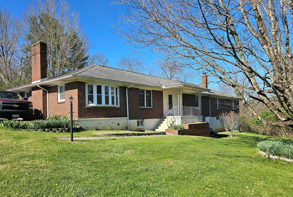 This home will absolutely amaze you with the amount of space and versatility it has to offer! This hidden gem is right in the middle of town, yet it's private. It's situated on 1.74 acres and has beautiful views! The main level consists of 4 BR's, 1.5 baths, living room, kitchen and den. But the real bonus, also on the main level, is a spacious in-law suite! It has an open living room/kitchen combination, large bedroom, private bath and laundry room. It's perfect if you need to move in an ageing parent or perhaps give your college student their own space. The home has been very well maintained throughout the years. The hardwood floors are in great condition. There is hardwood underneath the living room carpet. The kitchen has lots of beautiful custom cabinetry and Corian countertops. The cozy family or sunroom has ceramic tile flooring and a woodburning fireplace. If that wasn't enough, there's a full basement that offers finished and unfinished space. The basement area is great for a children's play area, exercise room or just for storage. There's a large building behind the house that is great for storing the lawn equipment or extra fun things like motorcycles, ATV's, etc. The convenient location is unquestionable, and the space that only one can dream of!