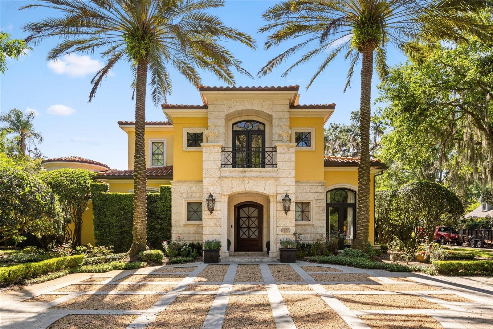 Custom Waterfront Estate located in the heart of Winter Park with a covered Boat Dock on Lake Maitland - the largest of the Winter Park Chain of Lakes. A timeless Neoclassical Italian home that exudes luxury and sophistication, spanning a total of 7,916 square feet. Built by Charles Clayton. Designed by Marc Michaels. The main house boasts over 7,100 sf with 4 bedrooms, 4 full bathrooms, and 3 half bathrooms. The detached Guest House/In-Law is approx. 500 sf, with 1 bedroom, 1 bathroom, two closets, and a wet bar. The detached Catering Room with half (pool) bath is approx. 350 sf with an additional refrigerator and wall-to-wall storage, conveniently attached to one of the two-car garages. Recently upgraded with a NEW barrel tile ROOF installed in 2023.

Enjoy expansive entertaining areas that seamlessly blend indoor and outdoor spaces, offering a grand setting for lavish gatherings. Outfitted with the finest custom finishes, gourmet chef's kitchen, equipped with top-of-the-line appliances, an oversized island, and large dinette space. Awe-inspiring private courtyard with heated pool and spa, covered porch, outdoor grill, and several separate terraces. Impressive primary suite with office and sitting area has separate his and hers ensuite bathrooms and closets. Stunning two-story closet with office on the second floor and laundry room on first floor. Impressive entertainment/media room with state-of-the-art projector, media equipment and electronic blackout shades. Second story features a spacious loft, 3 bedrooms, 2 full bathrooms, a laundry room and two balconies. Storage is abundant throughout this property. You will find two 2 car garages behind the electronic gated side facing driveway, one garage with a kennel and a Tesla charging station. Experience quintessential Winter Park living in this one-of-a-kind estate that is the epitome of opulence and grandeur.