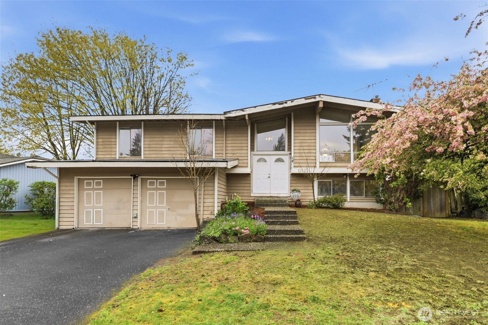Opportunity awaits! This spacious 5-bedroom, 2.5-bath home offers 2,270 square feet of potential in a convenient location close to schools, shopping, and everyday amenities. With three bedrooms upstairs and two bedrooms downstairs, the flexible layout is ideal for multi-generational living, guests, or home office needs. The main level features a large, open living area with a wood-burning fireplace and a kitchen complete with granite countertops—ready to be refreshed and reimagined to your taste. Downstairs, you’ll find additional living space with a cozy gas fireplace, creating the perfect spot for relaxing or entertaining. Step outside to a back deck ready for your vision—repair, replace, or design the outdoor retreat you’ve always wanted. A large garage with ample storage adds to the home’s functionality and appeal. With great bones, generous square footage, and a versatile layout, this home is the perfect opportunity to build equity and make it truly your own.