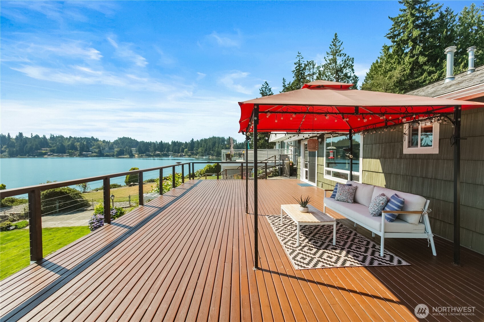 Very rare opportunity on coveted Madrona Point! This remodeled medium-bank waterfront home offers a true saltwater lifestyle w/63 feet of water frontage, your own private boat launch, and breathtaking Oyster Bay views. Inside, enjoy refinished hardwood floors, granite counters, a natural gas fireplace, tile shower, & shutter blinds. Step onto the expansive 800 sqft deck or down the new galvanized beach stairs to your beach where the water is often 15° warmer! The 1280 sqft heated garage features skylights, 220V, attic lift, & cedar siding. Recent upgrades include metal roofing under the deck, 200 amp panel, heat pump/a/c, leaf guards, new slider with dog door, and more. Close to PSNS, Hwy 3, ferries, and downtown. PNW bliss!