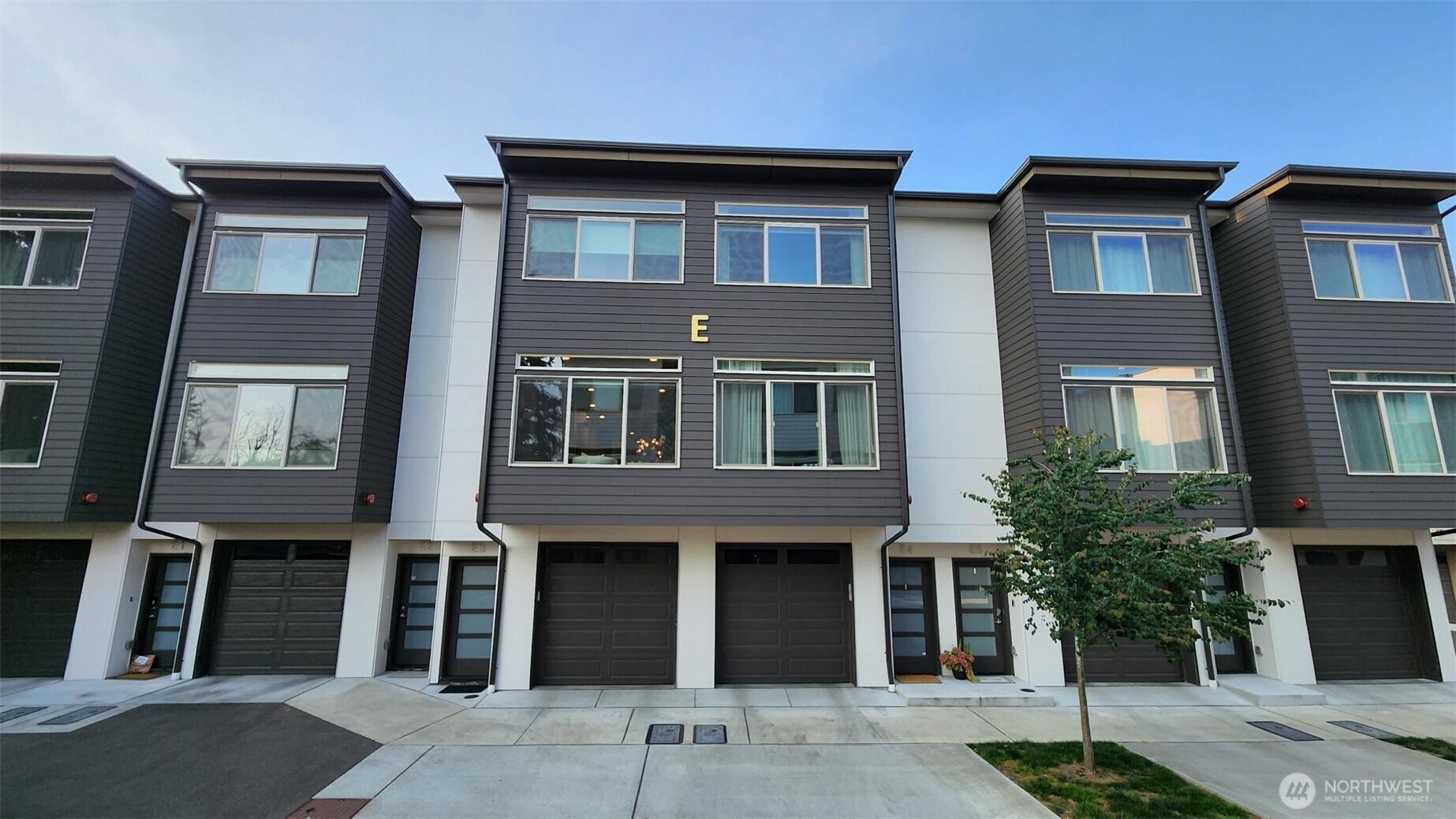Immaculately maintained townhome offers exceptional value with modern finishes and amenities. Inviting open floor plan is spacious and bright, showcasing living areas with 10' ceilings, slab quartz countertops, soft close cabinetry, luxury vinyl plank flooring, and designer  lighting throughout. Master bedroom features en-suite bath and walk-in closet. Kitchen features stainless appliances, full  height backsplash, under-cabinet lighting, and sliding glass door access to your private deck that overlooks the yard and  trees. Efficient mini-split heating and cooling maintains comfortable temperatures year-round. Oversized tandem garage can fit at least 2 cars, and includes shop space, storage, and an EV charger outlet. Original owner just had the interior freshly painted, and has installed blinds on the windows that are included with the sale. Common areas include green space, benches, and a fully fenced dog-run. Quiet, off-street location is just minutes' drive from Downtown Edmonds, Puget Sound beaches, Mukilteo, Paine Field, Alderwood Mall, and Lynnwood Transit Center. Come and see why this townhome offers the best value in the area!