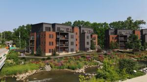 The Pelham is a brand-new luxury riverfront condominium building being built, overlooking Mill Creek. This second-floor unit features two bedrooms and two and a half bathrooms, along with a private outdoor terrace. Located next to the B2B trail, across from Mill Creek Park North on the Mill Creek River. A 20-minute drive from Ann Arbor.. Modern amenities, underground parking, elevator building, and a Wide selection of finishes to select from. Building completion Fall 2026.