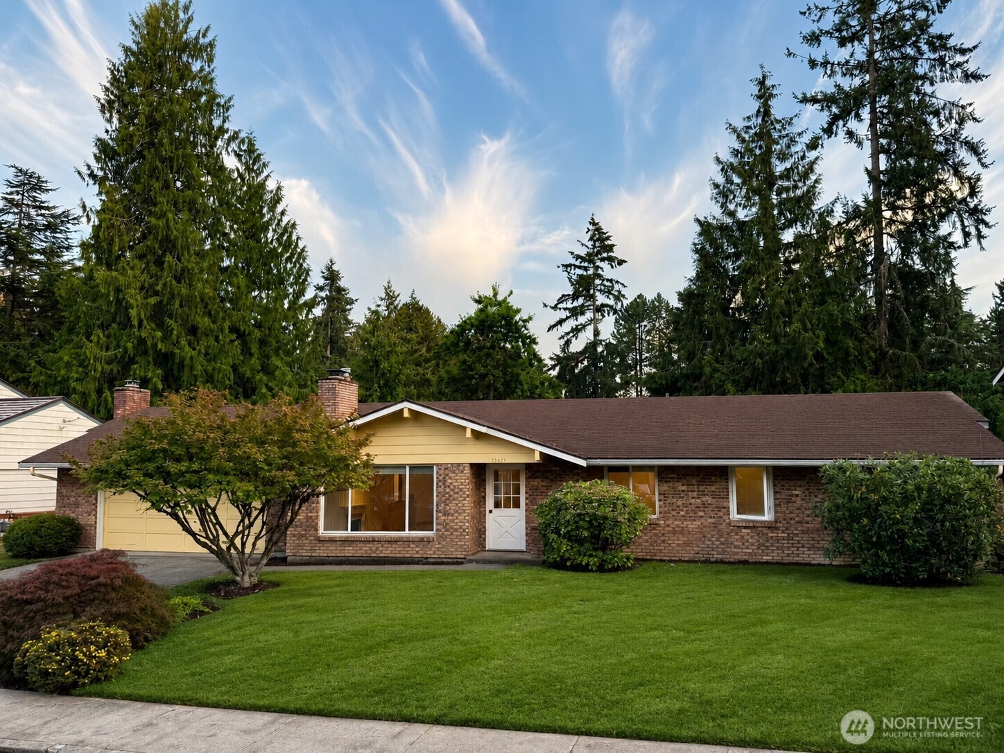 Rarely available and highly desirable, this classic Bellevue rambler offers the combination buyers have been waiting for: single-level living, a quiet street, a large level lot, a huge private fenced backyard, & no HOA. Located in the sought-after Bretton Wood community, this light-filled home blends timeless character with thoughtful updates & exceptional livability. Original hardwood floors bring warmth & character throughout, while newer windows, sliding doors, and custom Levolor blinds create a fresh, inviting feel. The updated kitchen features granite countertops, tile backsplash, and newer appliances, including a double oven. A gas or wood-burning fireplace anchors the spacious living area, while a large bonus room provides valuable flexibility for a media room, office, gym, playroom, or additional living space. The primary bedroom offers two closets & an ensuite bath. An oversized two-car garage is exceptionally well equipped with a workbench, cabinets, shelving, and additional storage above, plus a newer space-saving side-mount garage door opener. Gas furnace and hot water add comfort & convenience. Step outside to a peaceful, garden-like backyard with abundant room to relax, entertain, garden, or play. Enjoy an enviable location just blocks from Tam O'Shanter Golf Course & Park, w/ easy access to Bennett Elementary, Interlake HS, & beaches on Lake Sammamish. Minutes to Microsoft, light rail, shopping, dining, 520 & I-90. Rambler. 4 beds. Big, quiet lot. No HOA. RARE!