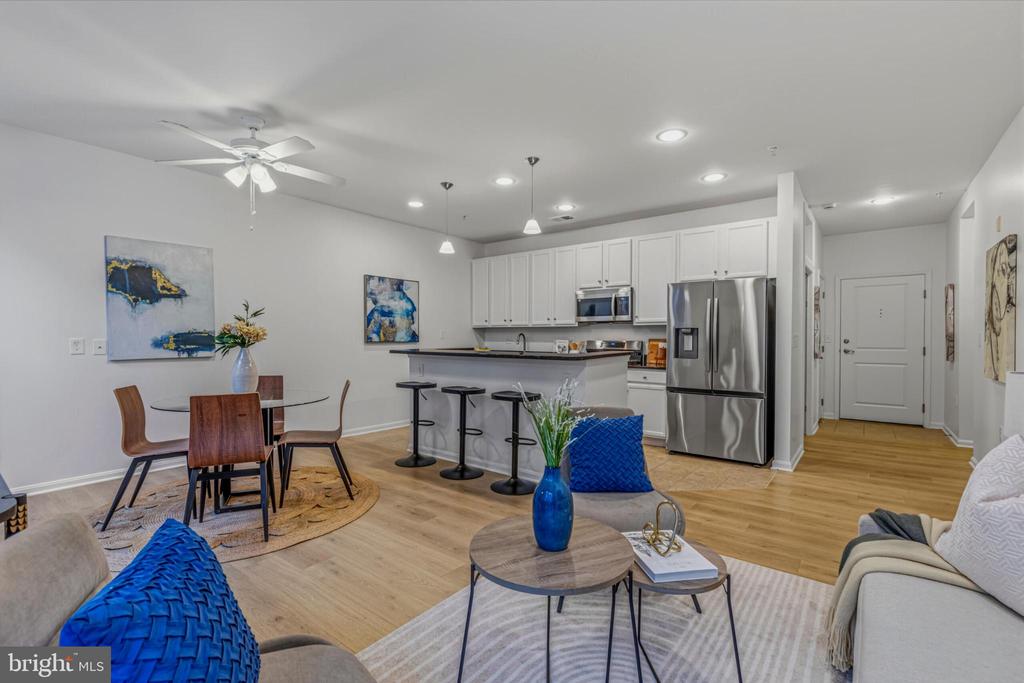 Discover this 1-bedroom plus den, 1-bathroom condo nestled in the desirable Halstead at the Metro II community. With an inviting open floor plan, this home seamlessly blends the living, dining, and kitchen areas, creating a warm and welcoming atmosphere perfect for relaxation or entertaining. The kitchen is a chef's delight, featuring a spacious island and all brand new stainless steel appliances, including a built-in microwave, gas range, and dishwasher. Enjoy the convenience of an in-unit washer/dryer. The luxurious vinyl plank flooring adds a touch of elegance while ensuring easy maintenance. Retreat to the serene bedroom, complete with a walk-in closet and a well-appointed primary bath featuring a tub shower. Ceiling fans and window treatments enhance comfort and privacy throughout the space. Step outside your private balcony to enjoy your morning cup of coffee. Have piece of mind knowing that the hot water heater was installed in 2021. Community amenities include an outdoor pool, fitness center, and indoor half size basketball court. With 24-hour security and concierge services, know that your packages and deliveries are safe. The property also comes with 2 deeded assigned parking spaces in a covered garage, ensuring convenience year-round. Located just a short walk to Dunn Loring Metro along the  Orange line, this home is perfect for those seeking a vibrant lifestyle with easy access to the city. This unit offers the perfect blend of comfort, convenience, and community. Schedule a private tour today!