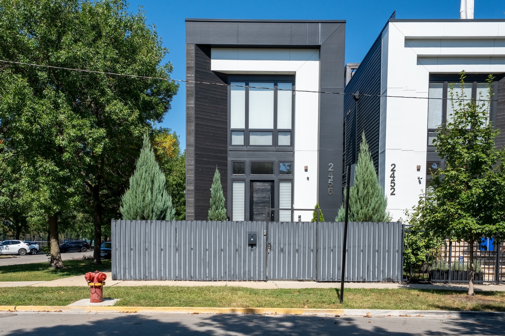 Architecturally stunning corner home in a 4-residence development by a leading Chicago builder, offering striking design, first-class finishes, and an exceptional level of detail throughout. The open-concept floor plan features soaring 11-foot ceilings, expansive windows overlooking Smith Park, and a dramatic open glass staircase that floods the interior with natural light.    At the heart of the home is a chef's kitchen with high-end appliances, custom cabinetry, and a large island that flows into the great room with a contemporary gas fireplace, French doors, and a built-out mudroom. Upstairs, the luxurious primary suite includes a fully built-out walk-in closet and a spa-like bath with dual vanity, soaking tub, frameless glass shower, and heated floors. Two additional bedrooms share a Jack-and-Jill bath, and a full laundry room completes the level.    The lower level offers two guest bedrooms, a full bath, a spacious recreation room with a full wet bar, and a second laundry area for added convenience. The crowning feature is the private rooftop terrace, complete with a pergola, fireplace, and penthouse wet bar-an entertainer's dream with skyline views.    Additional highlights include washer and dryer on both the upper and lower levels, sleek modern finishes, and abundant storage throughout. Located just steps from Smith Park, a five-minute walk to the Metra, and a quick commute to the Loop, this home offers the perfect blend of luxury and convenience.