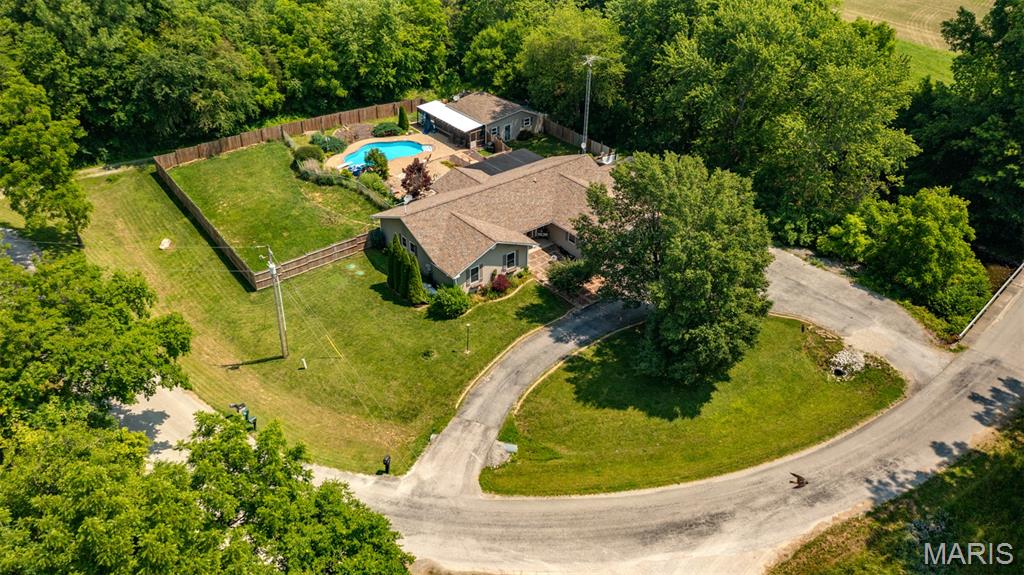 RURAL RETREAT! Welcome to your private oasis! 4BR 2BA home on 1.9 acres. Plenty of yard to enjoy the lush landscaping or relax in the in-ground salt water pool. Entertain both inside and out or, enjoy the peacefulness and privacy all by yourself. No detail has been overlooked, and this home is ready for you to move in and make it your own! Retreat to the primary suite with luxurious bathroom or enjoy your morning coffee right off of the primary bedroom. The floor plan is thoughtfully designed for both everyday living and gathering, with inviting living spaces and ample natural light throughout. Step outside to enjoy the expansive yard, partially fenced for pets, play, or peace of mind. Whether you're time on the porch, a summer swim, or a weekend barbecue by the pool, this property has something for everyone. Hardwood flooring, ceramic tile, crown moulding, 2 car attached heated garage, blacktop horseshoe drive, and sunroom...the list goes on and on! Pool house offers additional gathering and storage or workshop space. Call today and schedule your showing!