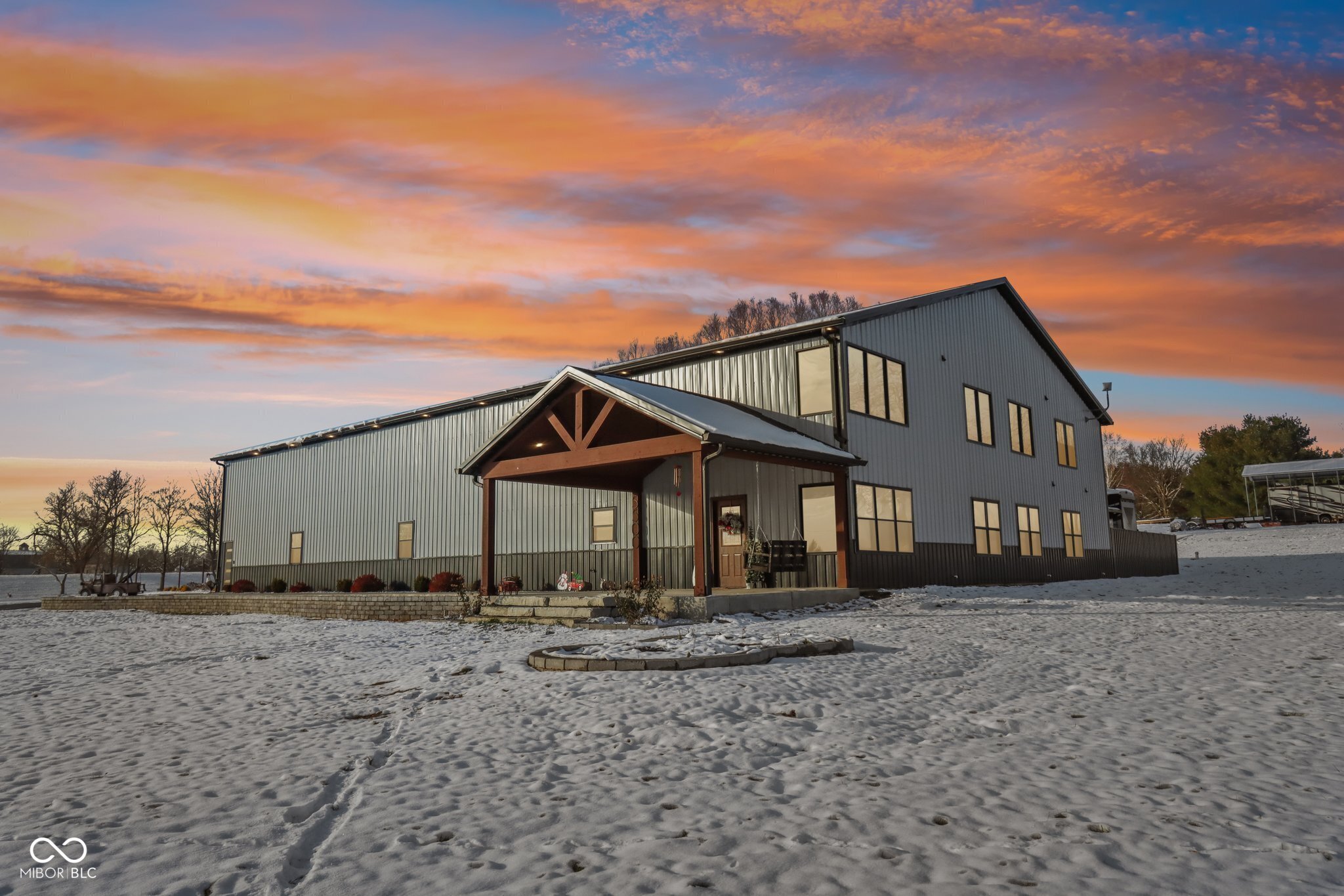 Experience unparalleled luxury and exceptional craftsmanship in this 2023 custom-built home set on 4 private acres. Boasting 4 spacious bedrooms and 2.5 beautifully appointed baths, this residence blends modern comfort with elegant design. The open-concept living area features soaring ceilings and a living room fireplace, perfect for cozy evenings or entertaining guests. The gourmet kitchen is a chef's dream with premium cabinetry, quartz countertops, a large island, and custom details ideal for hosting family and friends.  The primary suite is a true retreat, complete with a spa-inspired bath, soaking tub, walk-in shower, and high-end finishes. Secondary bedrooms are generously sized with thoughtful design touches and ample closet space.  The 60x70 garage is perfect for car enthusiasts or hobbyists, featuring office space, upstairs storage, and endless possibilities for collections, workshop, or recreational use. A 10x20 outbuilding provides additional storage or workspace, while the extended driveway ensures plenty of parking for guests and gatherings.  Step outside to your private resort: an inground heated saltwater pool, surrounded by premium hardscaping, and a custom concrete pergola with built-in fireplace, offering a year-round space for entertaining or relaxing in style. Every detail-inside and out-reflects high-end craftsmanship, from custom trim and premium flooring to upgraded mechanicals, windows, and smart-home features.  This one-of-a-kind estate offers privacy, luxury, modern amenities, and turn-key readiness. Rarely do homes of this caliber become available. Your luxury retreat awaits-schedule your private tour today!