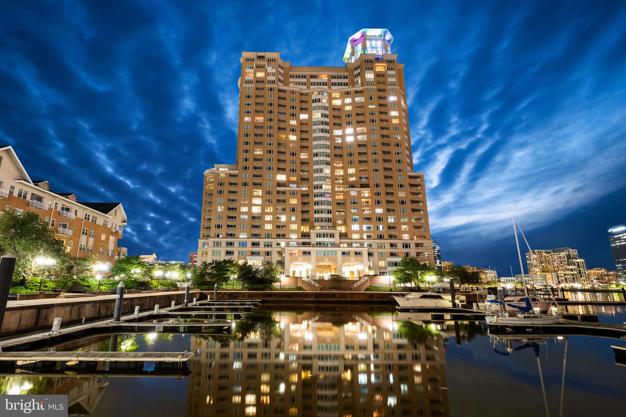 A complete 2023 reimagination of this space has created a tantalizingly sleek, chic and modern urban penthouse retreat that boasts breathtaking panoramic views of both the northern and southern city skylines and inner harbor. The open floor plan allows you to watch the boats come in or listen to summer concerts at Pier 6 Pavilion from the kitchen, living and dining areas! The stylish kitchen absolutely shines with quartz countertops, glass backsplash and matching stainless steel LG appliances. Any hour can be happy hour when you gather with friends at the breakfast bar, grab your favorite libation from the beverage fridge and recline on the balcony to watch the city lights come alive! With all the amenities you're looking for - concierge, indoor & outdoor pools, gym, grilling terrace, lounge, yoga room, front desk/security, and conference room PLUS 2 deeded garage spaces - this cosmopolitan condo exemplifies accessible luxury and incomparable comfort.Talk to Listing Agent about option to purchase furnished!