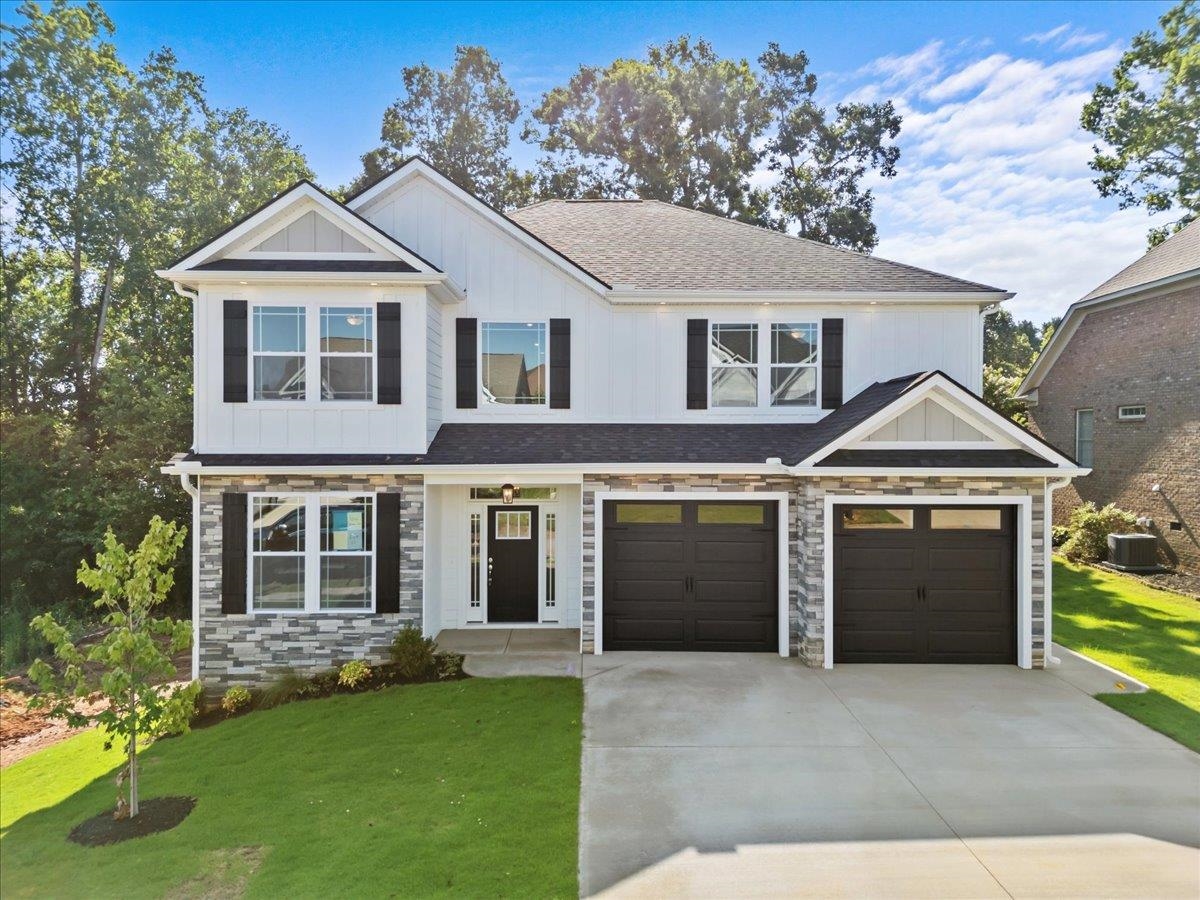 The RIDGE ELITE features a large open living area with 2-story ceiling and a stone fireplace. Master on the main level with trey ceiling, tile shower, and huge walk-in closet. Upstairs are 3 other bedrooms, and a spacious loft/nook space. Out back is a covered deck with gorgeous lake views. Granite countertops, LVP flooring, and stainless appliances are just a few of the features included. Lot 13.