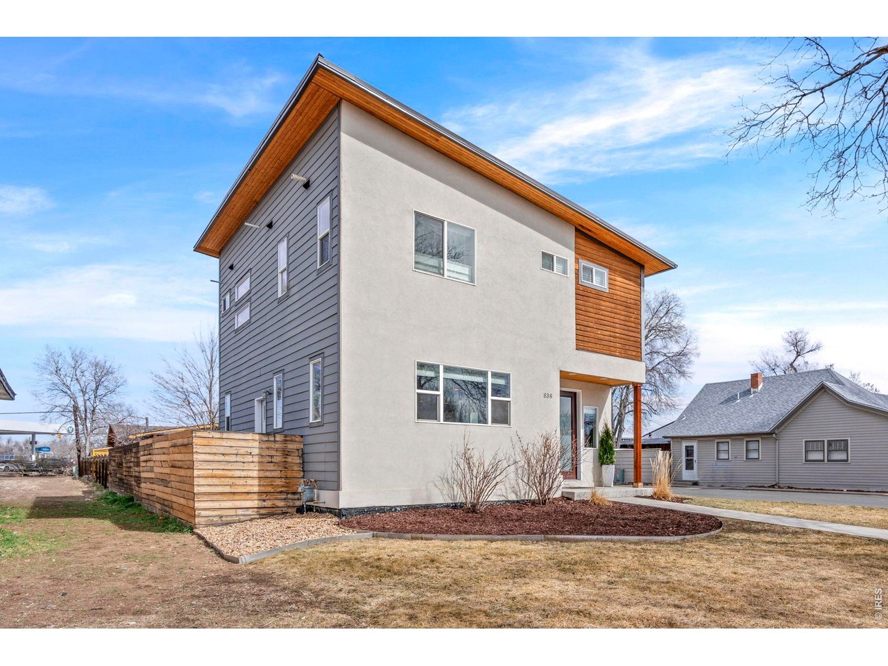 Modern living in the heart of Fort Collins! Located on a corner lot in the Old Town District, this newer two-story home delivers style, comfort, and a location that puts the best of the city within reach. A beautifully landscaped yard and eye-catching curb appeal create a strong first impression the moment you arrive. Step inside to a light-filled main living area featuring high ceilings, engineered hardwood flooring, and abundant natural light that create a warm and welcoming atmosphere. The open-concept layout allows each space to flow seamlessly together. The kitchen includes stainless steel appliances, quartz countertops, and a center island perfect for meal prep, casual dining, or hosting guests. The upper level features three well-sized bedrooms, including the primary suite with an en-suite bathroom and walk-in closet. Each space offers natural light and flexibility for a variety of uses. The home also includes central A/C for year-round comfort, a valuable feature in the area. Outside, the fenced yard provides a private outdoor setting complete with a concrete patio, ideal for outdoor dining or relaxing evenings. The one-car attached garage features wall to wall heavy 3/4" rubber flooring, high ceilings which can be used as an extra vertical space for storage, as well as a dedicated split unit with both heating and AC. This highly walkable location places you just minutes from CSU and the vibrant shops, restaurants, and nightlife of Old Town, making it easy to enjoy everything the city has to offer, right outside your door. No HOA!