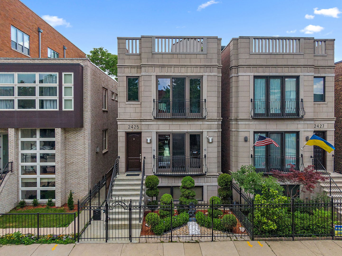 Welcome to this exceptional nearly 4,000 sq ft modern residence, where thoughtful upgrades redefine luxury city living! Situated in Ukrainian Village, this custom home offers every amenity imaginable-inside and out! Step into a sun-drenched floor plan with hardwood floors throughout (5 years old), and soaring ceilings that give way to meticulously designed spaces on every level. A true centerpiece, the kitchen is outfitted with an expansive island, Viking stove, Sub-Zero refrigerator, built-in warming drawer, beverage cooler, under-cabinet lighting, stone countertops, and sleek modern cabinetry. The home features two fireplaces (currently gas but easily convertible to wood-burning), custom California Closet systems throughout, central vacuum, and whole-home integrated speaker system including the rooftop deck. The spacious primary bedroom boasts two separate walk-in closets, a Sub-Zero beverage cooler, and a lavish en-suite bath with one of two steam showers in the home. Each bathroom is finished with modern, high-end materials, and the vent fans have all been replaced within the last 6 weeks for optimal comfort and efficiency. The fully Finished Basement offers heated floors, a wet bar, full laundry room with sink (2nd laundry hook up option located in 2nd floor hall closet), and a home theater with top-of-the-line soundproofing (or can be converted back to 5th bedroom by removing the soundproofing on the walls), all five reclining theater chairs, projector, and media equipment will convey with the sale-offering an incredible in-home cinema experience. Every inch of outdoor space is maximized with composite decking, including 2 balconies, and an impressively large (67X19) rooftop deck! This area has also been cared for practically with proper roof vents and perimeter flashings to prevent water intrusion. The gated entry adds privacy and security, while two outdoor sheds provide extra storage. The detached garage has epoxy floors and a brand-new universal EV charger.  There are 2 electric panels in the home (200 amp + 150 amp) for all of your electric needs, and the home is wired for interior and exterior cameras throughout. Replaced in 2025: all HVAC (4 total units / zoned), sump pump back up battery, and outstanding remote-controlled blinds less than a week old (with the click of 1 button, the blinds will all simultaneously open or close througout the entire level of the home)! Notable updates include all new windows, sump pump, and 3 beverage coolers (2023), washer and dryer (2024), dishwasher and microwave (2022), New Tear-off Roof (2013), 5 patio doors, siding on the rooftop deck, (2018), and water heater (2020) for added peace of mind. The following will remain in the home for a new Buyer to enjoy: pool table, all TVs and TV mounts, elliptical, and propane grill. At the end of the block, enjoy a true neighborhood experience with access to a tennis court, park, and splash pad-perfect for outdoor fun and community connection. Welcome Home!