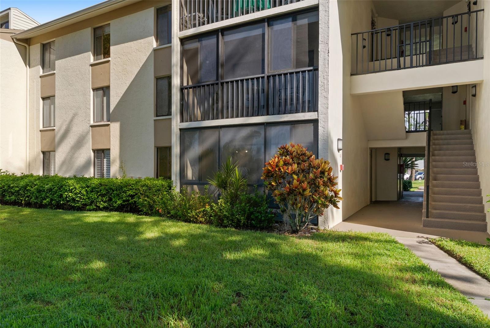 FIRST FLOOR LIVING WITH WATER VIEWS TO SWOON OVER! Gorgeous pond and clubhouse views greet you from this beautifully maintained first-floor unit in desirable Pine Ridge. Step outside the back entry and enjoy the winding trail that follows the oversized pond, perfect for a morning walk, evening stroll, or relaxing ride.FRESHLY PAINTED and featuring an open-concept kitchen and family room with NEWER VINYL FLOORING, this home offers an inviting layout designed for easy everyday living and entertaining. The primary bedroom features a fabulous wrap-around closet providing exceptional storage and organization.Step onto the screened-in porch and enjoy the year-round lanai lifestyle with insulated shade windows that can be closed for added comfort, keeping the space cooler in the summer and warmer in the winter. It’s the perfect spot to take in the peaceful water views and enjoy your morning coffee or evening relaxation.Pine Ridge offers wonderful community amenities including a community pool and clubhouse, winding sidewalks and scenic surroundings. Conveniently located near shopping, restaurants and schools, this home offers the perfect combination of comfort, convenience and a beautiful waterfront setting. Come see why this one is ready to swoon over!