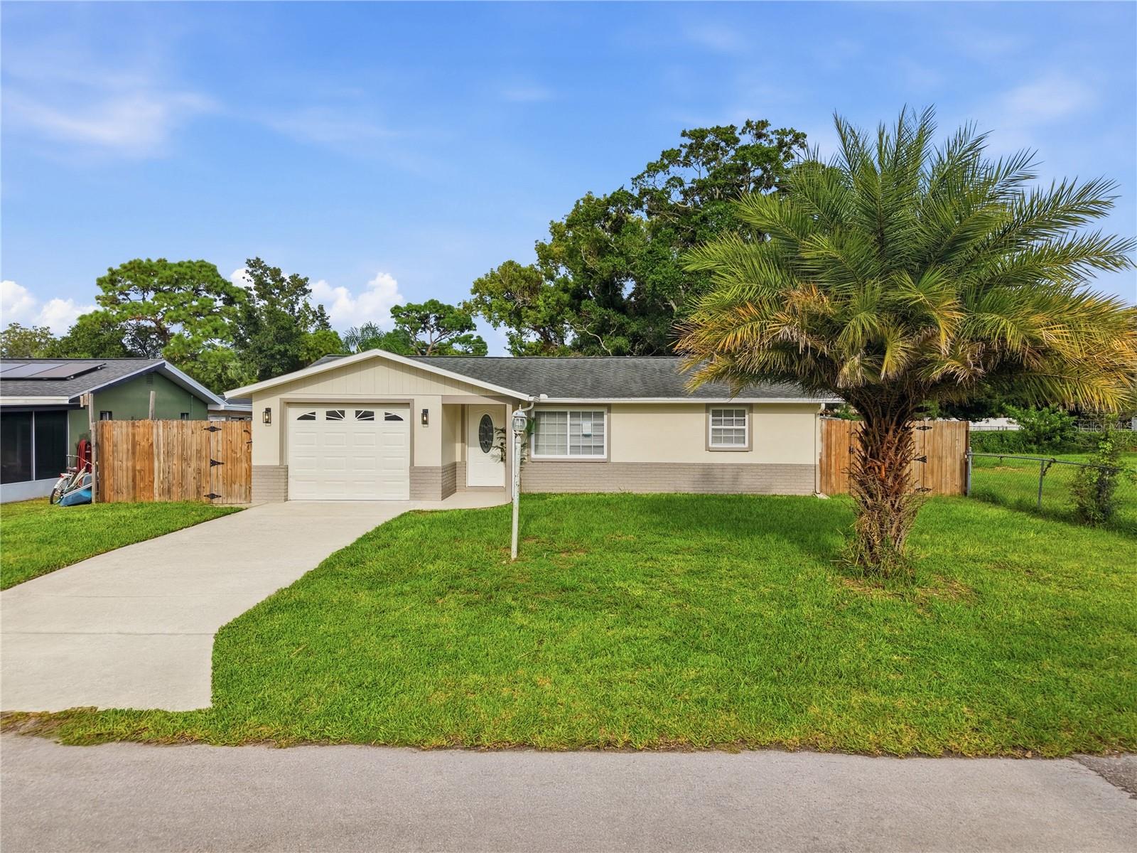 Virtually Staged. Fully renovated 2-bedroom, 1-bath home in Hudson, Florida, just minutes from the Gulf! Featuring a bright, open-concept layout, this beautifully updated home offers modern style, comfort, and convenience. Major improvements include new windows (2024), updated electrical panel and electrical work (2025), updated plumbing (2025), new fencing (2025), new exterior and sliding doors (2026), a fully renovated kitchen and bathroom (2026), new tile flooring throughout (2026), fresh interior and exterior paint (2026), and a new garage door with opener (2026). The kitchen includes brand-new appliances: refrigerator, range, microwave, and dishwasher. Additional updates include drywall improvements, modern low-profile LED lighting, and ceiling fans throughout. The spacious backyard offers plenty of room for relaxing, entertaining, or enjoying the Florida sunshine. Roof replaced in 2015 and A/C replaced in 2022. Move-in ready and conveniently located near beaches, shopping, dining, and everyday amenities—this is a wonderful opportunity to enjoy the Florida coastal lifestyle!