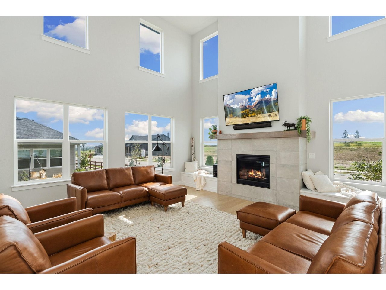 Beautifully maintained two-story home on a corner lot in the sought-after RainDance community, where panoramic views, flexible living spaces, and exceptional amenities create an unforgettable NoCo lifestyle! From mountain scenery to city lights, this home delivers a setting that truly needs to be experienced in person. Beautiful landscaping improvements throughout the rear and side yards create an inviting setting. Inside, an entry hallway opens into a main level featuring high ceilings, sunlit windows, and a cozy gas fireplace centerpiece. The kitchen is designed for entertaining, boasting granite countertops with abundant prep space, stainless steel appliances, a center island with seating, and a walk-in pantry. A versatile main-floor bedroom is conveniently located next to a bathroom, while a dedicated office near the entry provides a quiet space for remote work. The upper level begins with a spacious loft that connects three bedrooms. The primary suite features a spa-inspired 5-piece en-suite bath with a freestanding tub and walk-in closet, while secondary bedrooms share a Jack-and-Jill bath. Upper-level laundry adds everyday convenience. The unfinished basement provides excellent potential for future living space, hobbies, storage, or customization to fit your needs. Enjoy views of the RainDance National Golf Course from the front porch, while the fenced backyard and large raised deck create a private outdoor retreat. RainDance community is built for fun! Experience a neighborhood where the RainDance River Resort and local amenities are just a golf-cart ride away. Residents enjoy access to both RainDance and nearby Water Valley amenities, including lakes, beaches, and fishing, with optional golf or pool memberships at Pelican Lakes, RainDance Golf Course, and RainDance River Resort. This truly is resort-style living close to home!