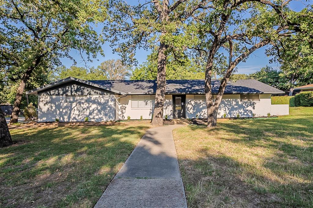 This beautifully renovated 3-bedroom, 2-bath home features fresh exterior and interior paint, a brand-new roof, and completed foundation repairs for peace of mind. Inside, enjoy new LVP flooring, plush carpet, new baseboards, and updated light fixtures. The kitchen boasts freshly painted cabinets with stylish glass doors, subway tile backsplash, a new stainless steel range with a modern vent hood, and a new dishwasher. Bathrooms have been refreshed, completing this move-in ready gem with both charm and function.