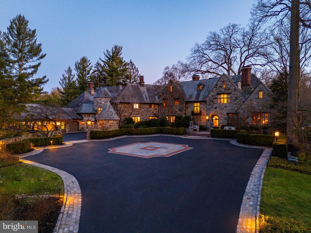 Following a successful tax appeal, the total annual taxes are $82,133 based on current millage rates.“Wooded Hill” is a significant Gladwyne estate privately set behind stone piers and entrance gates on nearly seven secluded acres of mature landscape and specimen plantings. A walled motor court, flagstone terraces, and formal garden areas introduce a 16,410 square foot main residence that has been carefully expanded and comprehensively renovated for modern living while preserving its original architectural character.The interior unfolds through a Mercer-tiled reception hall and central stair gallery, where arched passages and long sightlines connect the principal rooms. Detailed millwork, decorative ironwork, refined ceiling treatments, numerous French doors, and seven gas fireplaces are found throughout. Large windows on every elevation bring natural light into the home and frame views of the surrounding grounds.The main level is designed for both entertaining and daily use and includes formal living and dining rooms, a sunroom, billiards room, two family rooms, two private offices, and a gourmet kitchen with adjacent breakfast room at the center of the house.The primary suite occupies its own private wing and includes dual spa-style bathrooms, a sitting room, and a library balcony overlooking the two-story family room. Five additional bedroom suites each offer walk-in closets and private baths, and a second-floor library provides additional study or gathering space. In total, the residence offers eight bedrooms, including a fully self-contained two-bedroom apartment suitable for extended family, guests, or live-in staff.The daylight walk-out lower level is arranged for recreation and entertaining and features a custom bar, fitness room, theater with tiered seating, full bath, and direct access to the pool terrace and gardens.A separate two-bedroom guest house, accessed through a stone courtyard, has been renovated with contemporary finishes and provides privacy for long-term visitors.The grounds function as both formal landscape and recreational setting, with expansive lawns, a swimming pool and pavilion, multiple terraces, winding crushed-stone paths, and a private golf green with three tee boxes.Additional features include a Cummins 100kW whole-house generator and a Control4 system managing lighting, audio, security, and pool operation.Located minutes from Gladwyne Village, King of Prussia, Center City Philadelphia, and major commuting routes, the property offers a private estate setting with close access to regional amenities.