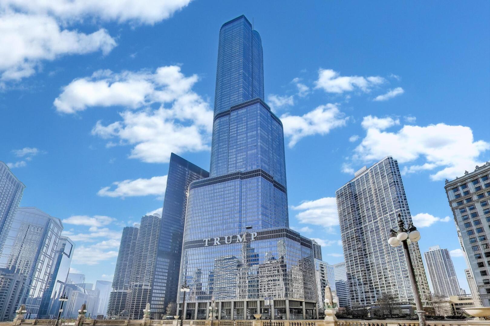 Explore this exceptional home through an immersive 3D tour and experience sophisticated city living in unit 40C at Trump Tower Chicago. Available fully furnished. Introducing a rare opportunity to own this sought-after 2-bedroom, 2.5-bathroom floor plan at the iconic Trump Tower. The unit is on a high floor and framed by dramatic 11-foot floor-to-ceiling windows, this exceptional residence captures breathtaking cityscape views and an abundance of natural light, all complemented by electronically controlled window shades for effortless comfort and privacy. The contemporary split layout is ideal for both privacy and entertaining, featuring two spacious bedroom suites positioned on opposite sides of an expansive open living area. Rich hardwood floors, custom built-ins, and designer finishes elevate the elegant interior, while refined architectural details create a polished, welcoming atmosphere. The chef-inspired kitchen is appointed with SubZero, Wolf, and Miele appliances, granite countertops, and a sleek breakfast bar that is perfect for morning coffee or evening cocktails. A dedicated laundry room and same-floor private storage room add functionality and convenience. Retreat to the luxurious primary suite, complete with a walk-in closet, full wall of custom storage, and a spa-like bathroom featuring dual vanities, a whirlpool tub, and a separate glass-enclosed shower. As a resident of Trump Tower, you'll enjoy access to world-class, hotel-style amenities, including 24-hour door staff, a state-of-the-art fitness center, indoor heated pool, fine dining, a world-renowned spa, private dog walk, valet, and in-residence room service and housekeeping. One premium parking space is included. Set in the heart of River North, just steps from the Magnificent Mile, Michelin-starred restaurants, and lakefront walking paths, Unit 40C offers a rare combination of luxury, convenience, and iconic views. Chicago living at its absolute best.