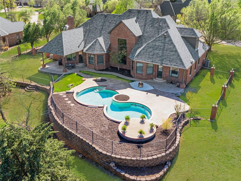 Welcome to 18632 Wolf Creek, a timeless design paired with modern livability in this truly exceptional residence. Positioned on a prominent corner lot spanning over half an acre within the highly sought-after, security gated community of Mulholland. The layout is designed for both daily living and effortless entertaining, with a spacious central family room that connects seamlessly to the kitchen and breakfast nook. The gourmet kitchen is thoughtfully appointed with updated appliances, double ovens, expansive counter space, sub zero refrigerator, and abundant storage equally suited for intimate meals or larger gatherings. A front room off the entry offers flexibility as a formal living or dining space, while a stunning dedicated study with built-in bookcases and storage provides a functional work or library setting. The recently reimagined primary suite serves as a private retreat, highlighted by a designer-crafted built-in with refined cabinetry and tailored storage. A downstairs guest suite with ensuite bath provides comfort and privacy for visitors, while three additional upstairs bedrooms include one with a private ensuite and two connected by a Jack-and-Jill bath. A spacious bonus room adds flexibility for recreation or relaxation. This home is equipped with a full suite of smart technology, including a whole-house generator, Starlink Wi-Fi, app-controlled exterior lighting and sprinkler system, Google Nest cameras, and MyQ garage access. Outdoors, mature trees line the back of the property, creating a private and serene setting. The pool provides a strong foundation for a future outdoor retreat, with both the pool and landscaping supported by well water offering efficiency without compromise. Additional features include a 375 sq ft (MOL) heated and cooled storage space, accessible from the fifth bedroom or via a walk-up staircase from the garage suited for storage, hobbies, or workspace. This is truly one you won’t want to miss, schedule your showing today!