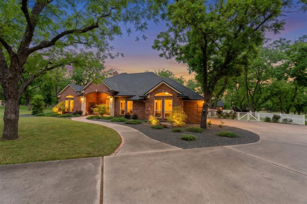 If you've been dreaming of wide-open space without giving up the conveniences of modern living, this is the one. Nestled on 3 breathtaking acres inside the gated community of Pecan Plantation, just a short drive from Granbury & under an hour from DFW, this fully renovated 4BR, 3BA home, delivers the peaceful country lifestyle you've been craving, with every luxury upgrade you'd expect in the city. Inside, the gourmet kitchen is stocked with KitchenAid appliances, granite countertops, a butler's pantry, & large walk-in pantry. The open, entertainer-friendly layout flows through two dining areas, a spacious living room & a sunroom finished with pine wood walls & ceiling. Custom cabinetry, 4 & a half inch colonial baseboards, crown molding and barn doors give rooms a warm, elevated feel — while major system upgrades including PEX plumbing, dual HVAC units, roof with solar exhaust fans, leaf-filter gutters, windows, doors, electrical, plus a full security system, mean you can simply move in & enjoy. Spa-worthy bathrooms feature a jetted master tub with heater, an oversized Jack & Jill tub, all-new tile, fixtures, and glass shower doors. The oversized laundry room with sink & attached 3-car garage round out the practical side of this extraordinary home. Step outside & you'll forget you ever needed the city. Backyard centers around a sparkling saline pool & right beside it, a stunning 1,200 sq ft pool house complete with a custom kitchen, beverage fridge, ice maker & full bath. Workshop with electric, sink & roll-up doors makes it equally functional. Mature pecan trees, lush landscaping, full irrigation, RV parking, & horses allowed complete your private retreat. And when you do want to venture out? Pecan Plantation delivers. Enjoy 24-7 gated security plus an unparalleled lifestyle with golf, swimming pools, tennis, pickleball courts, fine dining, pharmacy, bank, car wash, grocery store & more, all without leaving the gates. Come see it, Life happens here!