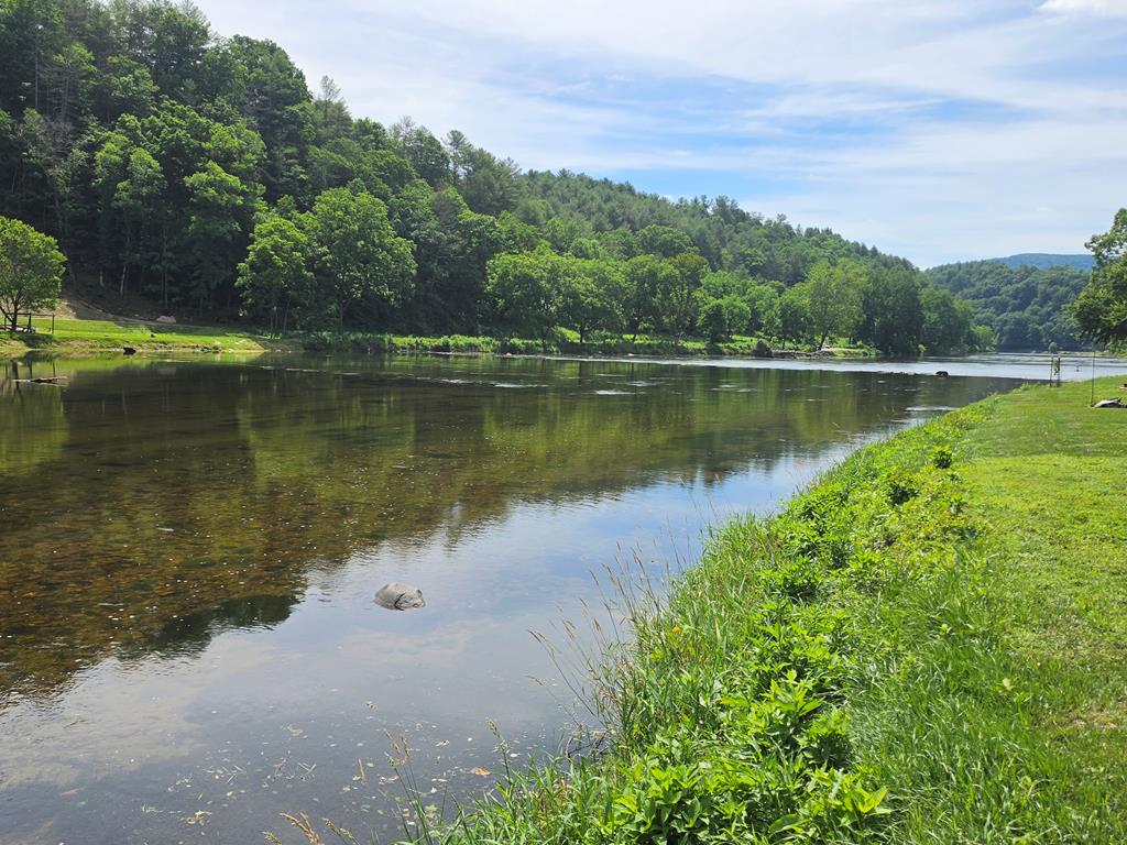 Enjoy river life in the Blue Ridge Mountains with this nice recreational lot on the New River, located along the Virginia and North Carolina state line in the New River Campground. Bring your camper, kayaks, boat, rods and reels, grills, and family, and get ready to relax by the campfire after a day on the water. Whether you enjoy fishing, boating, kayaking, or simply sitting back in a chair and taking in the peaceful river setting, this lot offers a great getaway spot to enjoy all the New River has to offer. Conveniently located within minutes of Independence, VA, Sparta, NC, Grayson Highlands State Park, and more, this property puts outdoor recreation, mountain scenery, and small-town conveniences all close by.