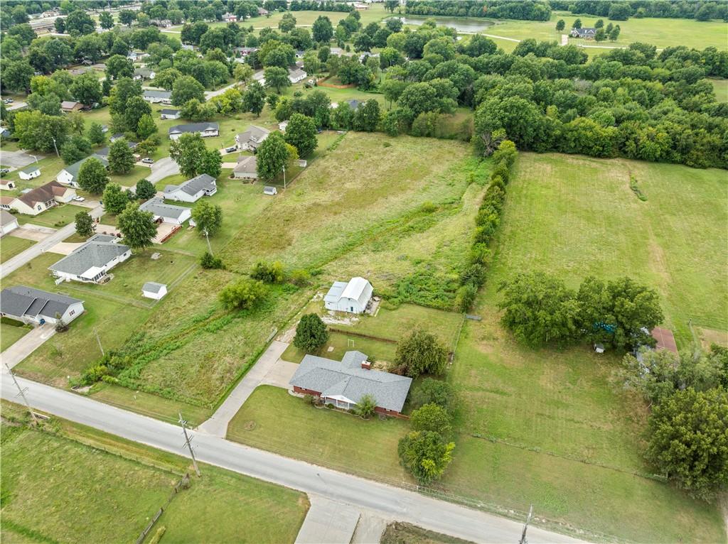 Smart, Stylish & Set on 4 Acres +/- Just on the edge of Town!

This all-electric brick home blends modern convenience with rural charm. Inside, you'll find 3 bedrooms, 2 bathrooms, and a spacious open-concept layout featuring a cozy wood-burning fireplace with a brick surround and blower fan. The primary suite includes an en suite bath, and one of the secondary bedrooms is currently used as an office.

High-tech upgrades include a full URC Total Control Smart System with Alexa/Google integration, motorized blinds in the kitchen and primary bedroom, LED color-changing lights, a whole-home sound system, and updated LVP flooring throughout the main areas. The kitchen-dining combo is highlighted by a brand-new tile backsplash and functional breakfast bar.

Additional perks include a walk-in shower, main floor laundry, mudroom, sunroom, and geothermal heating and cooling for year-round comfort and efficiency. Plus a BRAND NEW ROOF!

Outside, enjoy a fenced backyard with a concrete patio wired for surround sound and a nearby fire pit—perfect for relaxing or entertaining. A century barn offers endless versatility with a refinished upper level, workshop, grooming space, livestock shelter, and fenced pasture with automatic waterer and electric.

The oversized side-entry garage includes extra storage space and a gravel parking pad. With 4 acres, wet weather creek, and pipe/steel fencing, this property is ideal for those seeking space, smart living, and a rural lifestyle—just a short drive from town.