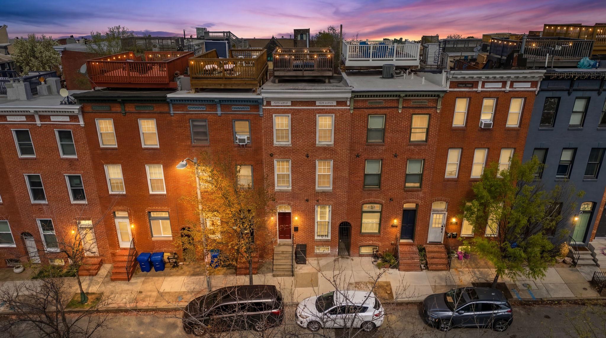 This fabulous and updated Butchers Hill rowhome is perfect for City living! Only a few blocks from beautiful Patterson Park, it has abundant living space, private parking, and a roof deck. It is also nearby to Johns Hopkins Hospital, restaurants, shopping, and the Fell's Point/Canton waterfront. The main level has an inviting open layout with a bright living room, separate dining area, half bath, and stunning kitchen. The kitchen has a large island, Viking cooktop, stainless appliances, breakfast nook, and extensive cabinetry with integrated lighting. French doors in the kitchen lead to the parking pad and sally port. The second level offers two spacious bedrooms, laundry and full bath. The third-level primary suite has a bedroom with vaulted ceiling, walk-in closet, and private bath. The primary bathroom features a soaking tub, separate shower, double vanity and heated floor. The lower level has a versatile finished flex space, full bath and large utility/storage room. The living space continues outdoors with multiple decks. Including the rooftop deck which has amazing City views! This well maintained home was fully renovated in 2017 and has so many amazing features. Schedule a tour today!