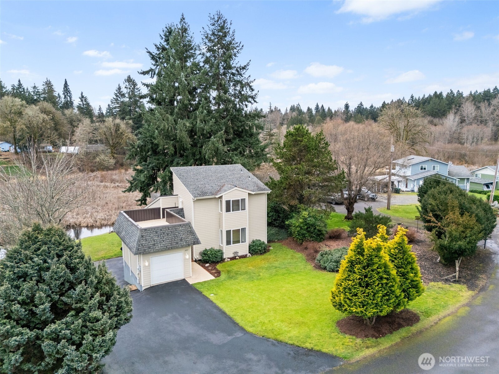 Welcome home to 10217 Sitkum Dr SE, where peaceful Lake St. Clair living meets everyday comfort and quality craftsmanship. With 72 feet of waterfront on a quiet inlet, this .283-acre property offers sweeping natural views filled with otters, eagles, hawks, and the kind of Pacific Northwest beauty that never gets old. Inside, the 1,958 sq ft home is spotless and truly move-in ready, featuring 2 bedrooms, 2 baths, abundant natural light, solid core doors, fully insulated interior walls, and finishes built to last. The kitchen shines with custom cabinetry, granite countertops, brand new stainless appliances, and a generous pantry. Step outside to the expansive back deck or unwind on the rooftop terrace off the primary suite, both perfect for soaking in lake views and sunsets. A one-car garage on the main level plus a two-car daylight basement garage offers incredible flexibility for storage, projects, or future living space. If you’ve been waiting for a serene waterfront home that feels solid, bright, and ready for its next chapter, this is your opportunity to live the lake life every single day.