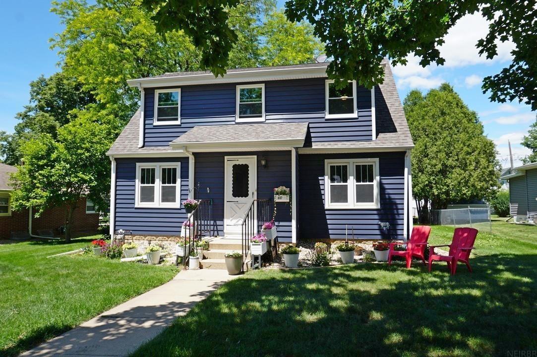 Charming 1 ½ story home in a great location! This 3-bedroom, 2-bathroom home has timeless character combined with modern updates, providing comfort and energy efficiency. Arched doorways, hardwood floors, and classic millwork are tastefully paired with fresh paint and new flooring. Newer roof, new siding, and vinyl replacement windows throughout. The home’s main level offers a large living room that opens to a formal dining room. The kitchen has a breakfast nook and an efficient layout providing ample storage. Down the hall is a full bath with a new tub-shower and a main-level bedroom. Upstairs, the extra-large primary bedroom features a double closet and bonus space well-suited to a sitting area, a dressing area, hobbies, or even an extra bed. Down the hall is another large bedroom with a walk-in closet and a half bath. A cozy nook at the top of the stairs overlooks the backyard. Outside, you are sure to enjoy the back deck and the yard shaded with mature trees. A one-car detached garage (18 ft x 20 ft) is conveniently located off the alley.  Situated in a desirable neighborhood near Lincoln Elementary School, the Middle School and High School campuses, and the Charley Western Recreational Trail, this home offers convenience, comfort, and a wonderful place to call home.