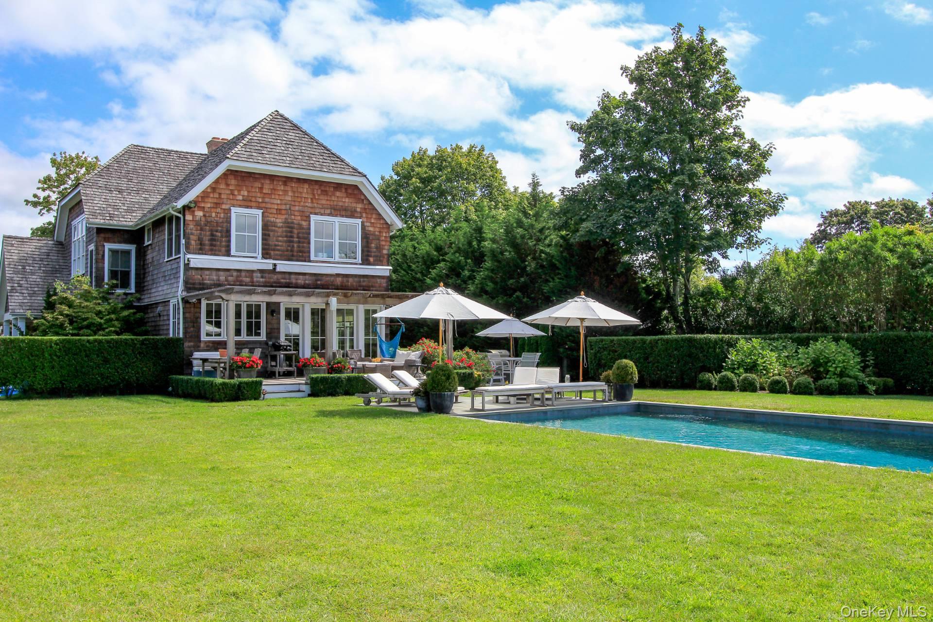 Set on a sprawling builder’s acre, this newly updated residence is a rare find just moments from Bridgehampton Village and the Hampton Classic. Thoughtfully designed for both comfort and elegance, this five-bedroom, five-and-a-half-bath home offers the perfect blend of luxurious living and modern convenience.

The sun-drenched open living spaces seamlessly flow into a designer kitchen, creating an inviting atmosphere ideal for entertaining. With two primary suites—one on each level—and three additional spacious ensuite bedrooms, this home is designed to accommodate guests in style, with generous closets and refined finishes throughout.

Step outside to a breathtaking outdoor oasis, where expansive decks and a serene patio overlook a beautifully landscaped pool area. The property is perfectly positioned to capture stunning Hamptons sunsets, offering a tranquil retreat for relaxation and gatherings. There is also room for an additional pool house or garage, enhancing the home’s future potential.

The fully finished lower level provides even more versatile living space, featuring a large family room, private office, additional bedroom, and full bath, making it ideal for work, leisure, or hosting guests.

A rare opportunity to own a turnkey luxury home in one of the Hamptons’ most coveted locations, this property is designed for effortless indoor-outdoor living.