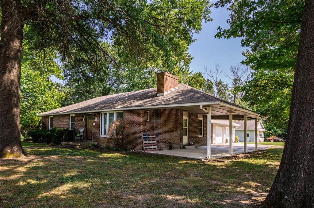 Check out this charming traditional ranch home situated on a desirable corner lot! This 3-bedroom, 2-bath home features a spacious primary suite with two closets for plenty of storage. Inside, you'll find a comfortable living room with a beautiful fireplace, a galley-style kitchen with an adjoining dining area, newer windows, and a dedicated laundry room conveniently located just off the kitchen. Step outside to enjoy the beautiful shade trees, a covered patio that's perfect for relaxing or entertaining, and not one, but two detached 2-car garages, offering exceptional space for vehicles, storage, or a workshop. Don't miss the opportunity to make this well-maintained home your own!