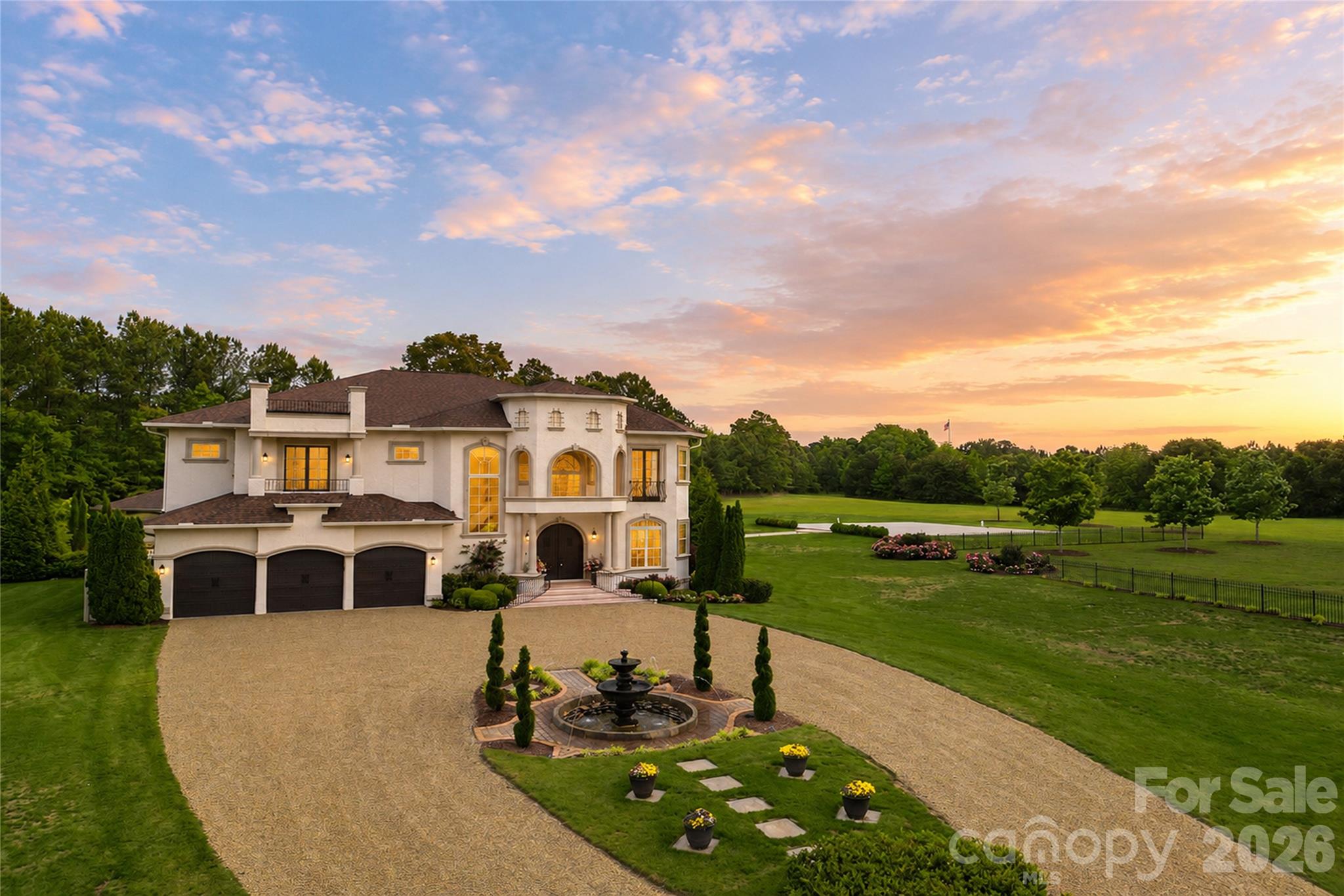 Set on more than 36 acres of rolling countryside, Belle Tesoro offers a rare opportunity to own a private estate designed for those who value space, seclusion, and control over their surroundings. Positioned just outside Spartanburg, the property delivers a level of privacy and scale that is increasingly difficult to find—where the approach itself, a gated and tree-lined drive leading to a circular motor court and fountain, immediately establishes a sense of arrival that is both refined and removed.The estate encompasses over 5,100 square feet of thoughtfully designed living space, where soaring ceilings, natural light, and custom millwork create an atmosphere of quiet sophistication. A dramatic sweeping staircase anchors the main level, complemented by a layout that balances everyday functionality with the ability to host and entertain with ease. The chef’s kitchen, formal dining room, and library provide structure and purpose to the home, while multiple fireplaces introduce warmth and character throughout. The primary suite serves as a true private retreat, featuring a spa-style bath, private balcony, and elevated views across the surrounding landscape.Outdoor living is equally intentional. Covered verandas and expansive patios extend the home into a resort-style setting, centered around a pool and fountain framed by manicured grounds and mature landscaping. Beyond the immediate homesite, the acreage opens into a blend of cleared pasture and wooded privacy, offering flexibility for a range of lifestyle uses—from recreational enjoyment to agricultural pursuits (see tax records for land designation). Conveniently positioned with access to Interstate 26, the property is just a short drive from the Carolinas’ premier equestrian destinations and the heart of Horse Country, further enhancing its appeal for those seeking space, privacy, and a connection to the region’s renowned equestrian lifestyle.For buyers seeking a property that prioritizes privacy over proximity and land over density, Belle Tesoro represents a compelling alternative to traditional luxury offerings. It is a residence defined not only by its architecture, but by the freedom and space it provides—an estate environment designed for long-term living, personal vision, and a level of separation that cannot be replicated in more conventional settings.