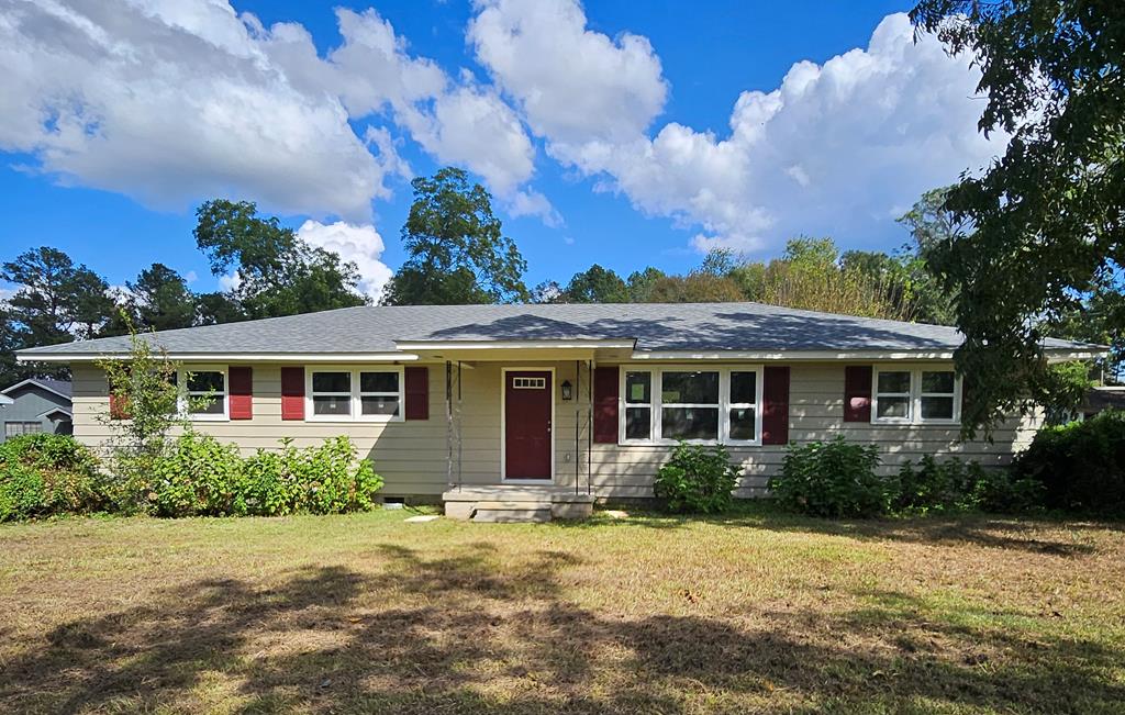 Step into this like-new gem, where modern charm meets thoughtful design! Completely reimagined with a reconfigured floorplan and total makeover, this spacious and bright 4-bedroom, 2-bath home sits on just under an acre—perfect for downsizers, first-time buyers, or savvy investors. Located just on the edge of town, you'll enjoy the peace of country living with the perks of being close to shopping, dining, hospitals, and retail. The open, split-bedroom layout offers the perfect balance of privacy and entertaining flow.  The kitchen is a true centerpiece, featuring stainless steel appliances, granite countertops, and a large island wrapped in shiplap with an oven that not only offers additional cabinet storage but perfect for entertaining.  The microwave is just as convenient with its own custom built in nook.  Recessed and pendant lighting adds warmth and functionality, while the separate dining area opens through double French doors to your expansive, level backyard retreat—perfect for outdoor entertaining or simply unwinding in peace.   Just off the kitchen, is the massive, private primary suite. This restful space includes its own double-door entrance leading to a small patio area, a large walk-in closet, and a luxury-style bath complete with a beautifully subway tiled step-in shower and double granite vanity sinks with a custom built in linen pantry.   On the opposite side of the home, you'll find a separate laundry room and the generously sized guest bedrooms offer ample closet space and share a larger-than-typical guest bath with a tiled tub/shower combo and granite-topped vanity.  Outside, enjoy the convenience of an oversized 2-car carport with an additional covered patio area—perfect for gatherings or shaded relaxation. A powered storage shed adds even more functionality to the already spacious and level yard.  With a new roof, HVAC, windows, water heater, new electrical and plumbing throughout, fresh paint inside and out, and luxury vinyl plank flooring, fixtures, and lighting throughout, all the major updates are already done.  Snag this beauty before someone else does, especially at a price that's just as attractive as the home itself!