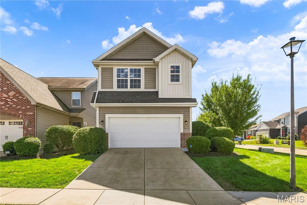Set on a corner lot with an open orientation that provides greater separation from neighboring homes, this former builder display home offers three beautifully finished levels of living space in a convenient St. Peters location.  The bright and inviting main level features 9-foot ceilings, wood-look laminate flooring, and an abundance of large windows that fill the living areas with natural light. The kitchen offers tall 42-inch cabinetry with crown molding, granite countertops, stainless steel appliances, a pantry, and a pass-through opening that connects the kitchen visually with the main living area. A built-in floor-to-ceiling bookcase adds architectural interest, while a new ceiling fan completes the freshly updated living room. A spacious dining area, main-floor laundry, and powder room provide additional convenience.  Upstairs, a large loft creates a second full-size living area, enhanced by wood-look laminate flooring and distinctive pendant lighting. The oversized primary suite features double-door entry, a coffered ceiling with ceiling fan, walk-in closet, and ensuite bath with a raised-height double vanity. Additional bedrooms and another full bath complete the upper level.  The professionally finished lower level significantly expands the usable living space with a large family/recreation room, finished bedroom with egress window, full bathroom, and rough-in for a future wet bar or sink. The lower-level walls have been professionally painted, and the bedroom features new carpet installed in September 2026.  Originally used as a builder display home, the property also features an insulated and heated two-car garage. Outside, enjoy a deck, lawn irrigation system, architectural shingles, and the advantages of low-maintenance living. As a convenience to its residents, this neighborhood offers individual mailboxes at each residence, eliminating the inconvenience of shared or group mailboxes. The monthly community fee includes lawn care, irrigation, and mulch maintenance.  The home has been extensively refreshed in preparation for sale, including professional painting of the interior walls and ceilings throughout, detailed finish and caulking work, professionally cleaned and polished flooring, new lower-level bedroom carpet, and a new main-level ceiling fan. The result is a clean, bright interior ready for its next owner.  Located in the Fort Zumwalt School District with convenient access to I-70, shopping, dining, recreation, and everyday services throughout St. Peters and the surrounding area.