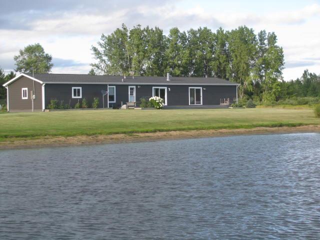 19.5 Acres, mostly open, level and well maintained. Almost 2 acre ‚Å“L‚  shaped pond that wraps around the three bedroom, two bath, 1755 sq.ft. home built in 2003. Living room and family rooms share the double sided wood burning fireplaces. Over the past few years, the home owner has completely redone the kitchen, both bathrooms, and flooring inside. Outside, vinyl siding, shingled roofing and both front and back decks. The attached garage has a 2100 gallon fresh water holding tank for the homes domestic water supply. About five acres of evergreen pine trees are at the back beyond the pond. This pond is about 18 feet, has three aerators, and is stocked with fish. The 30x40 pole barn has electric and lots of room for storage. Located near the end of a paved dead end road, private and peaseful setting, with plenty of wildlife, about a mile from Lake Huron.